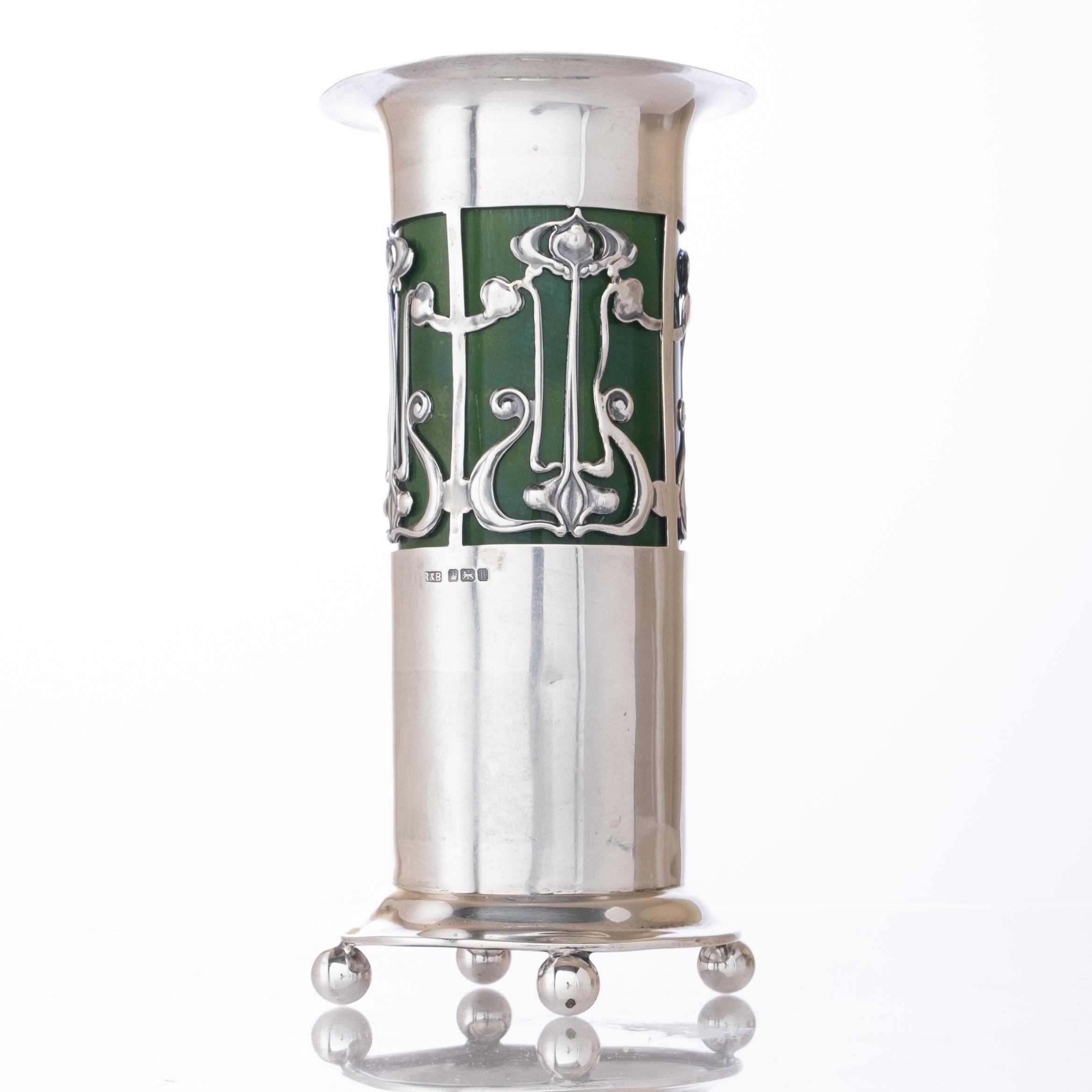 English sterling silver art nouveau-period vase with green glazed ceramic insert. The mark to the silver appears to be that of Roberts & Belk, Sheffield.

The firm was established in Sheffield in 1809 under the name of Furnyss, Pole & Turner. From