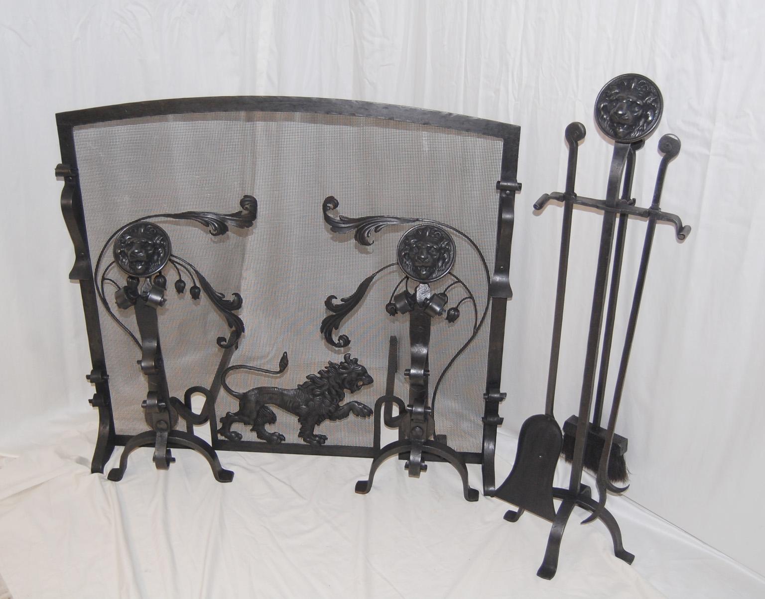 English Arts and Crafts Wrought and Cast Iron Fireplace Set with Lion Motifs. It is unusual to have an entire fireplace set that has survived in tact for over 100 years, but this is one. It includes fireplace screen, pair of lion headed andirons,