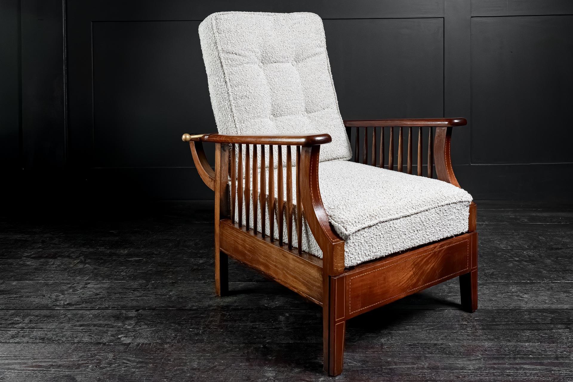 Extending English arts and crafts metamorphic salon smokers chair in the manner of William Morris retailed by Liberty's of London with pull out foot rest creating a sumptuous lounger. Oak and Mahogany with intricately detailed marquetry. Super