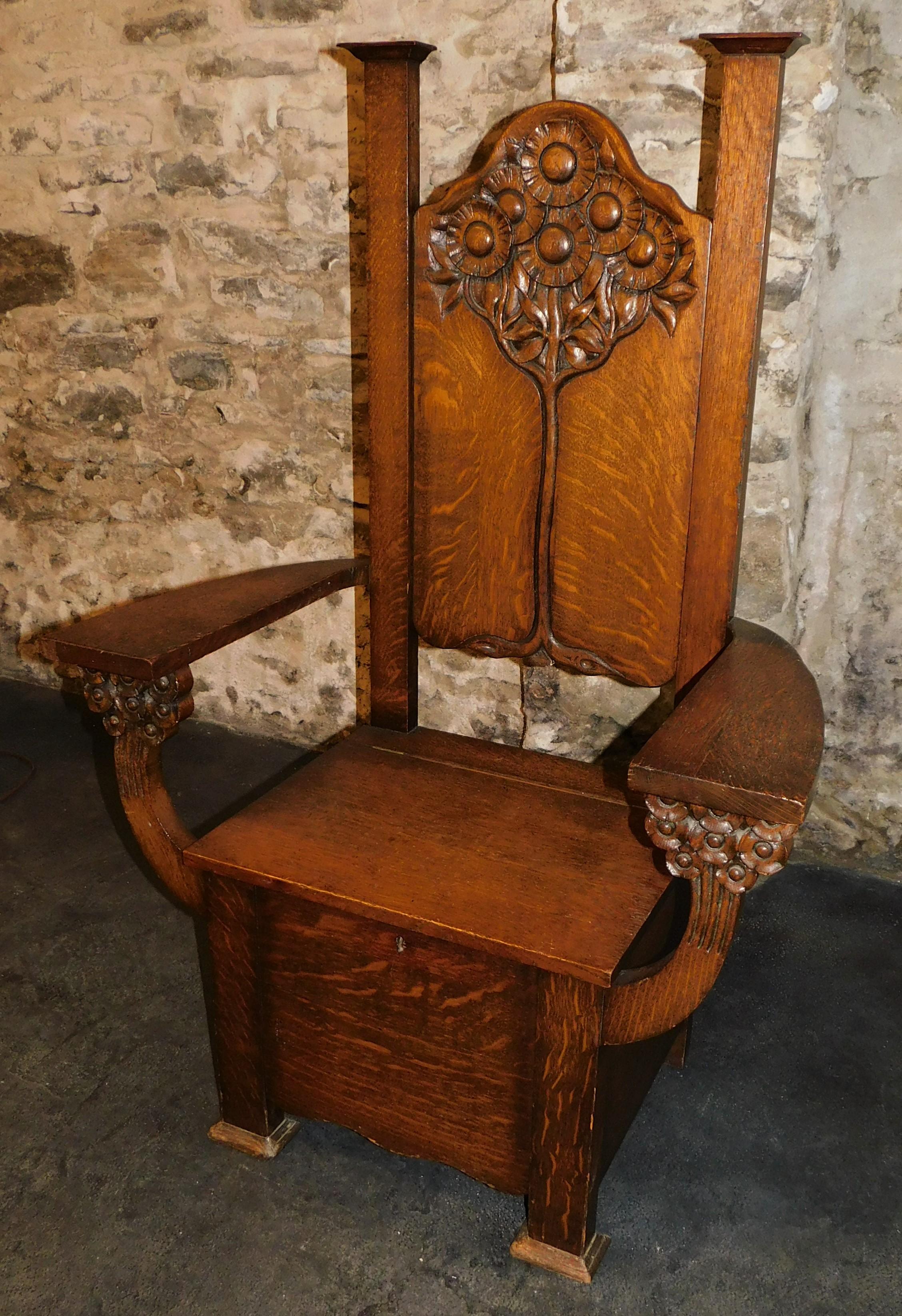 Attributed to Edwin Ridgeway this beautifully carved 19th century quarter cut oak Arts & Crafts mission, captains chair or hall bench. With carved sunflowers or daisy's under the arms, with a tree of life design on seat back. With locked storage,