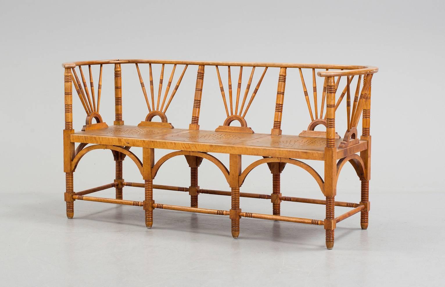 An Arts & Craft movement three-seat bench 
The solid birch frame supporting the seats with open star motifs
England, circa 1890.
