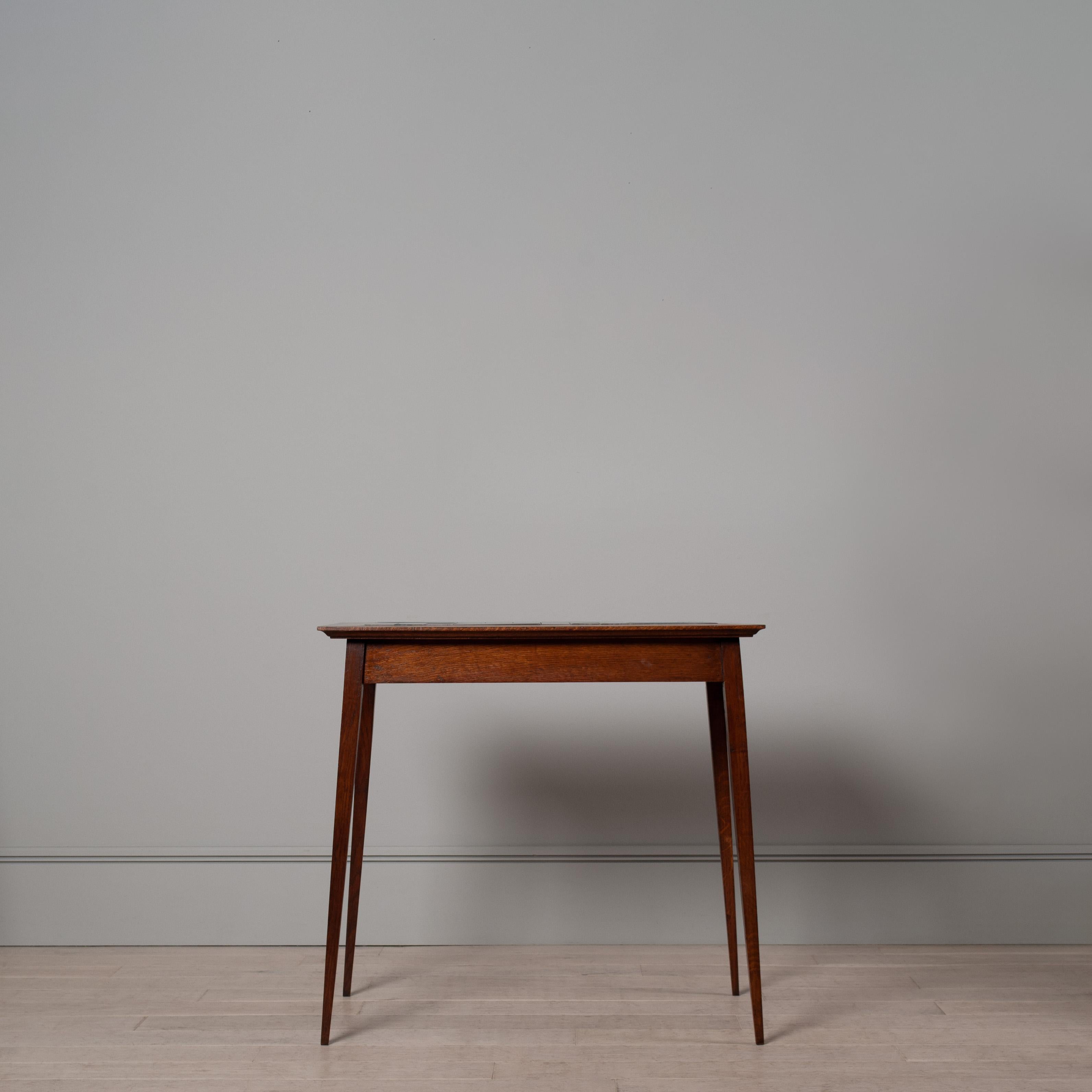 A charming and very well proportioned English Arts and Crafts console table, circa 1900. Constructed from Oak with beautiful blue ceramic tiled centre.
Lovely sharp tapering angled legs. In good condition and solid structure. No wobbles.

The