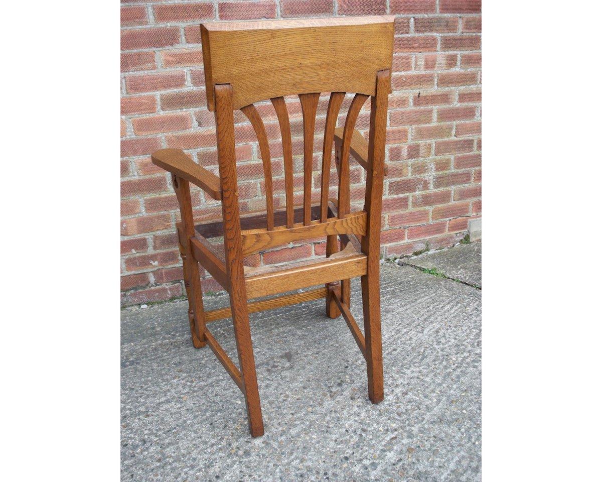 Early 20th Century English Arts & Crafts Oak Dining Chair with Stylised Floral Cut-Outs to the Arms For Sale