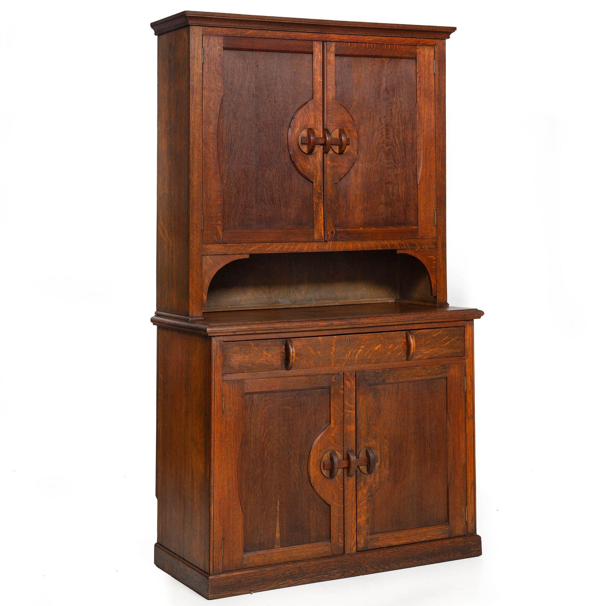 ENGLISH ARTS & CRAFTS OAK TWO-PART CUPBOARD
With a step-back form  clever carved wood latching mechanisms  circa 1920
Item # 403PPK18Q

This is such a fun step-back cupboard. We are particularly taken by the original hand-carved and shaped wooden