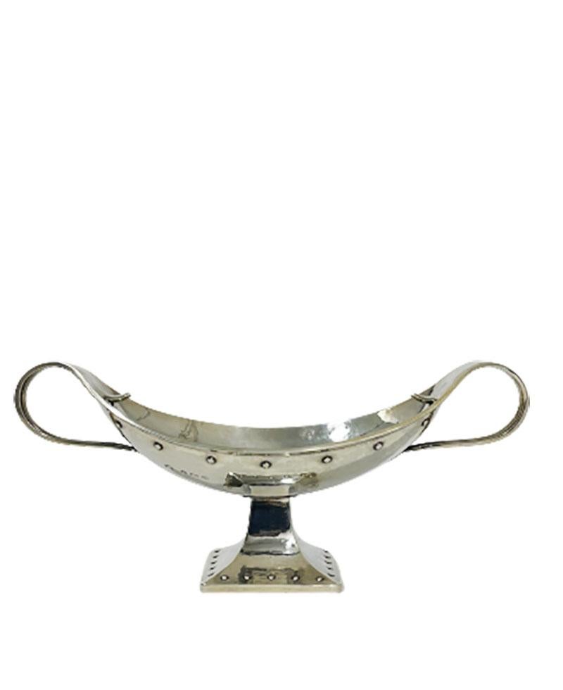 English Arts & Crafts silver bowl by George Laurence Conell, Birmingham, 1931

A silver hammered bowl raised on a square foot, with floral and nail decoration
Marked with the Silversmith George Laurence Connell, mark used during 1913-1932 (G.L.