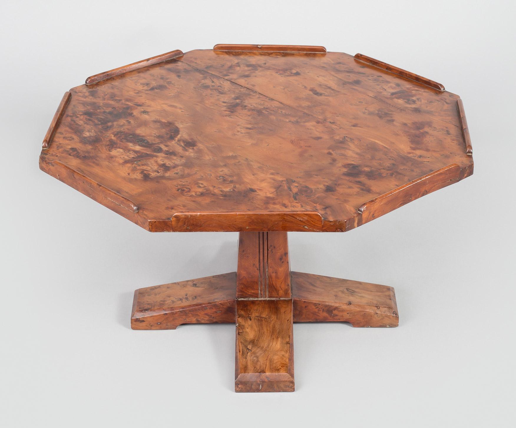 English Arts & Crafts movement octagonal-shaped burr yew wood Lazy Susan, the rotating top mounted on a squared pedestal with a four footed base. The label on the bottom of the base reads: Arthur W. Simpson (Hubert Simpson) The handicrafts, Kendal