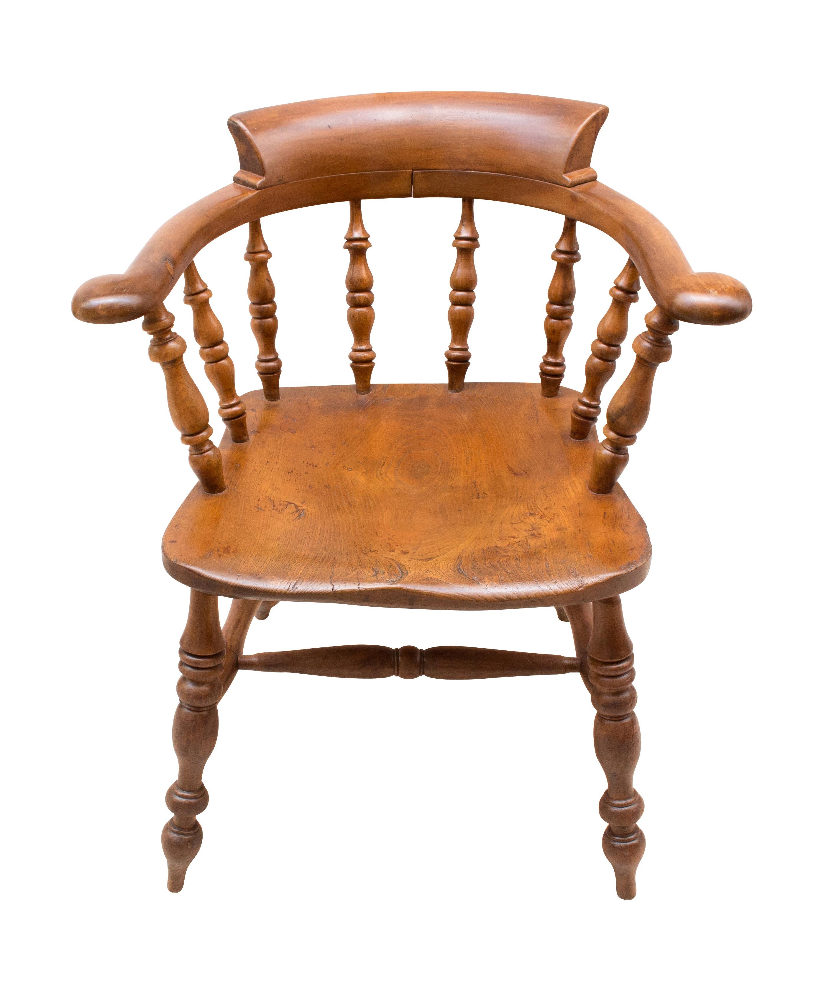 This Captain chair has boldly turned legs and spindles, hand-carved seats and back panels with an elegant sweep combined with solidly built ash construction including double stretchers. Made of the time, circa 1860. The chair has a beautiful patina.