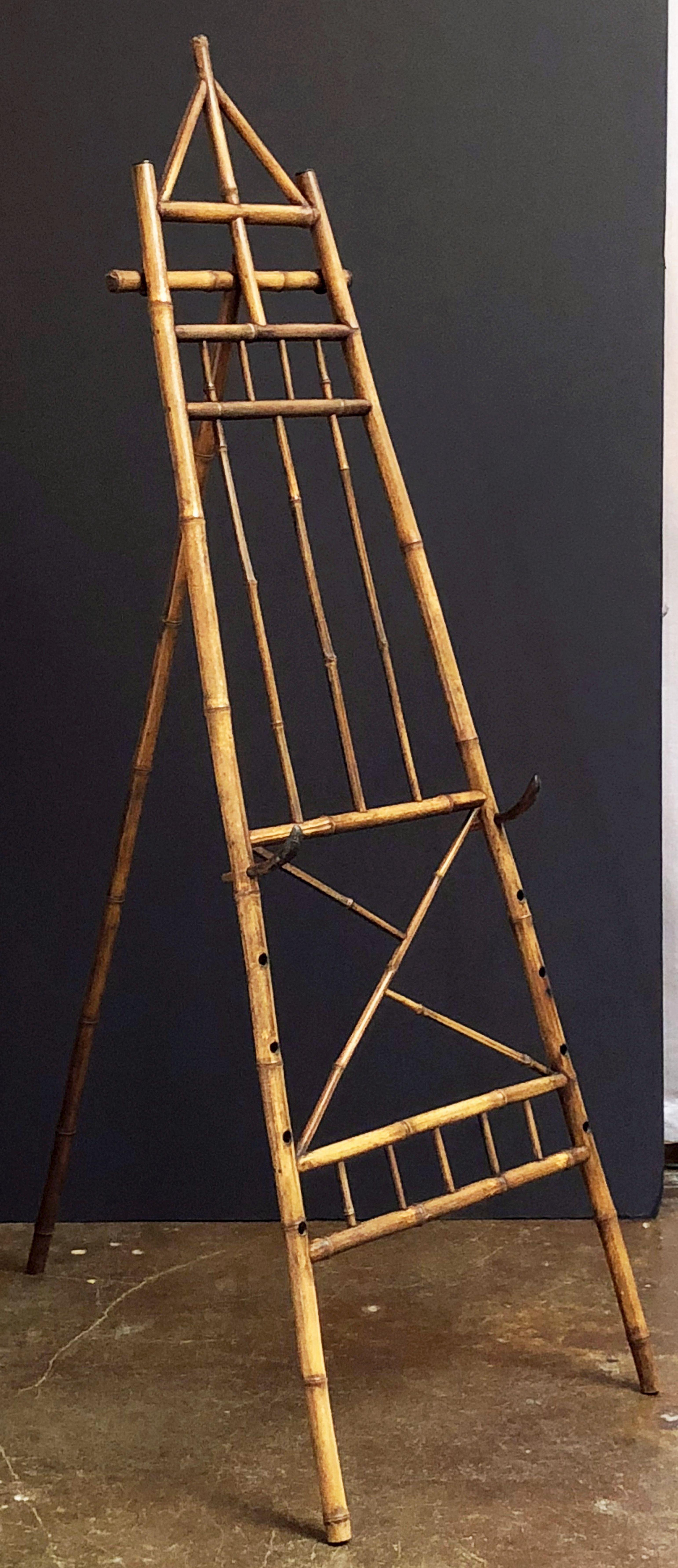 A Fine English bamboo display or artist's easel, from the Aesthetic Movement period, featuring a handsomely patinated frame with adjustable bamboo pegs for supporting framed art.

Dimensions: H 79 inches x W 26 1/4 inches x D 45 3/4 inches.