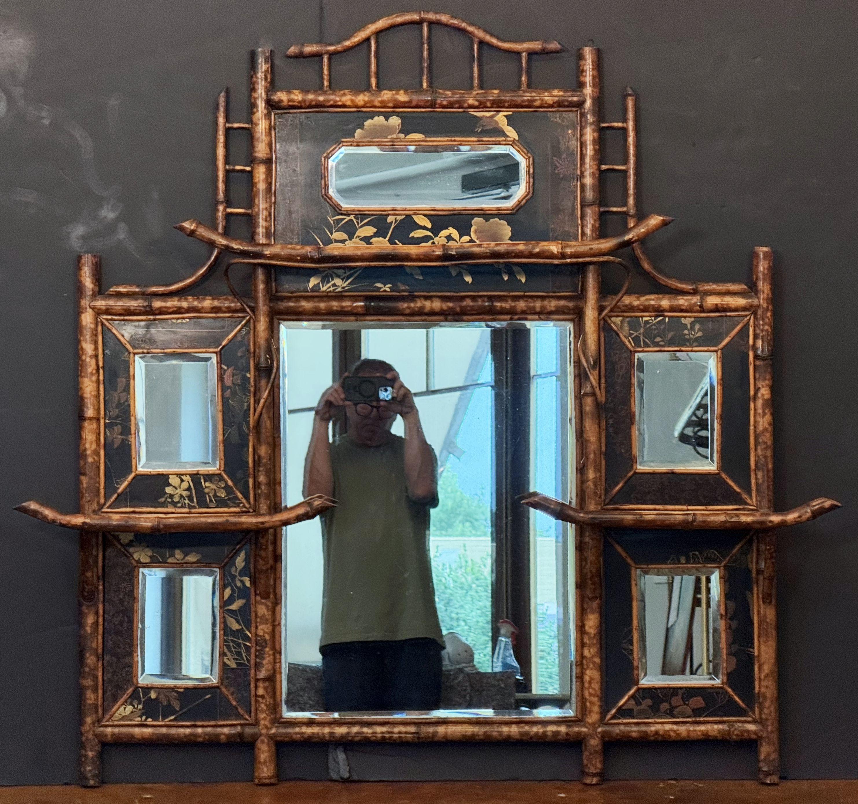 A fine English bamboo over mantel or wall mirror with a beautiful Aesthetic Movement design, circa 1870-1910, featuring a bamboo frame with lovely bamboo fretwork around the circumference, surrounding a rectangular beveled portrait mirror with an