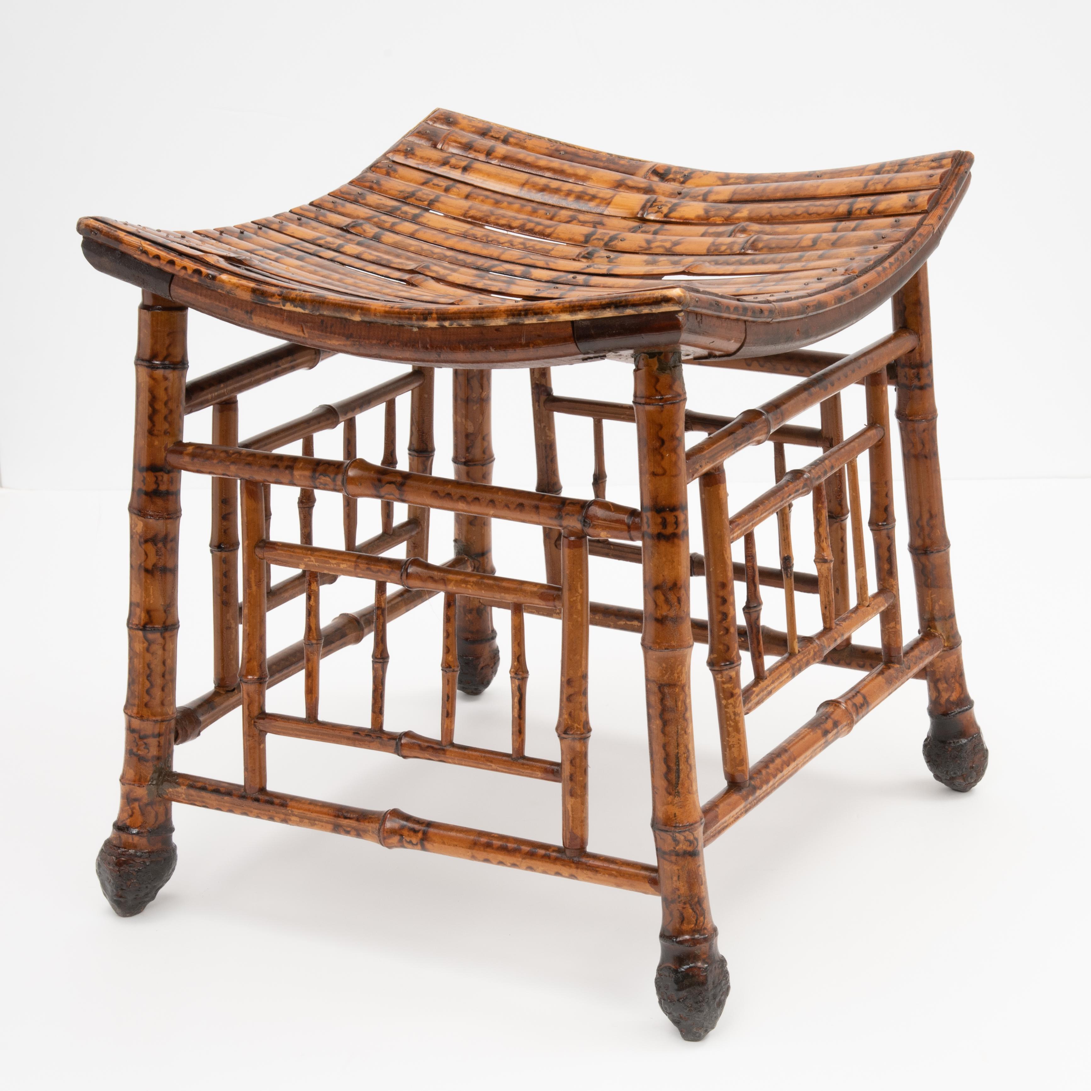 An English Egyptian Revival bamboo Thebes stool from the early 1900s, with slatted curving seat and root bamboo legs.