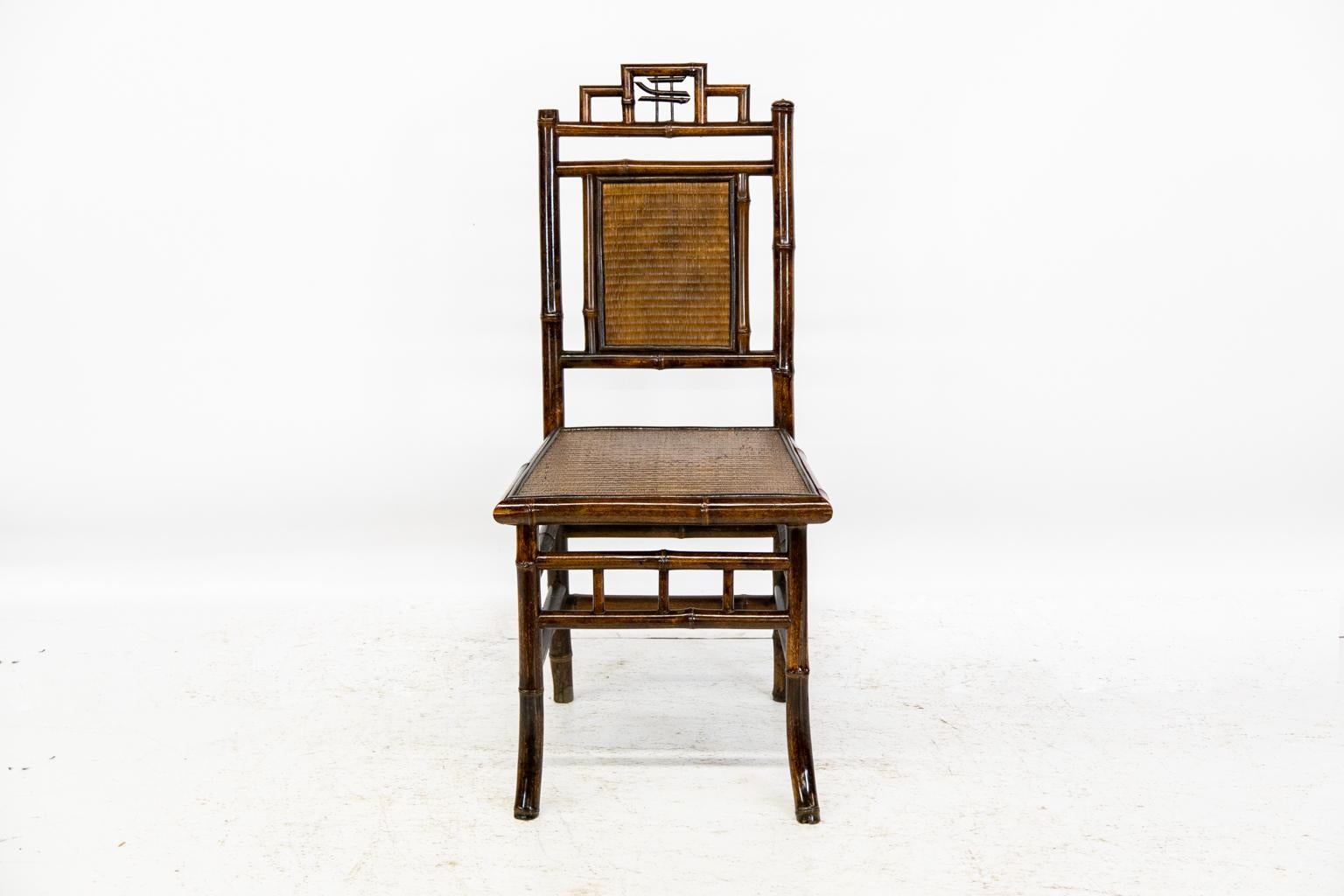 English bamboo side chair has a raffia back and seat, both framed by split bamboo molding. The seat has a galleried stretcher on the front and double stretchers on the other three sides. The front legs have forward splay for stability.
   