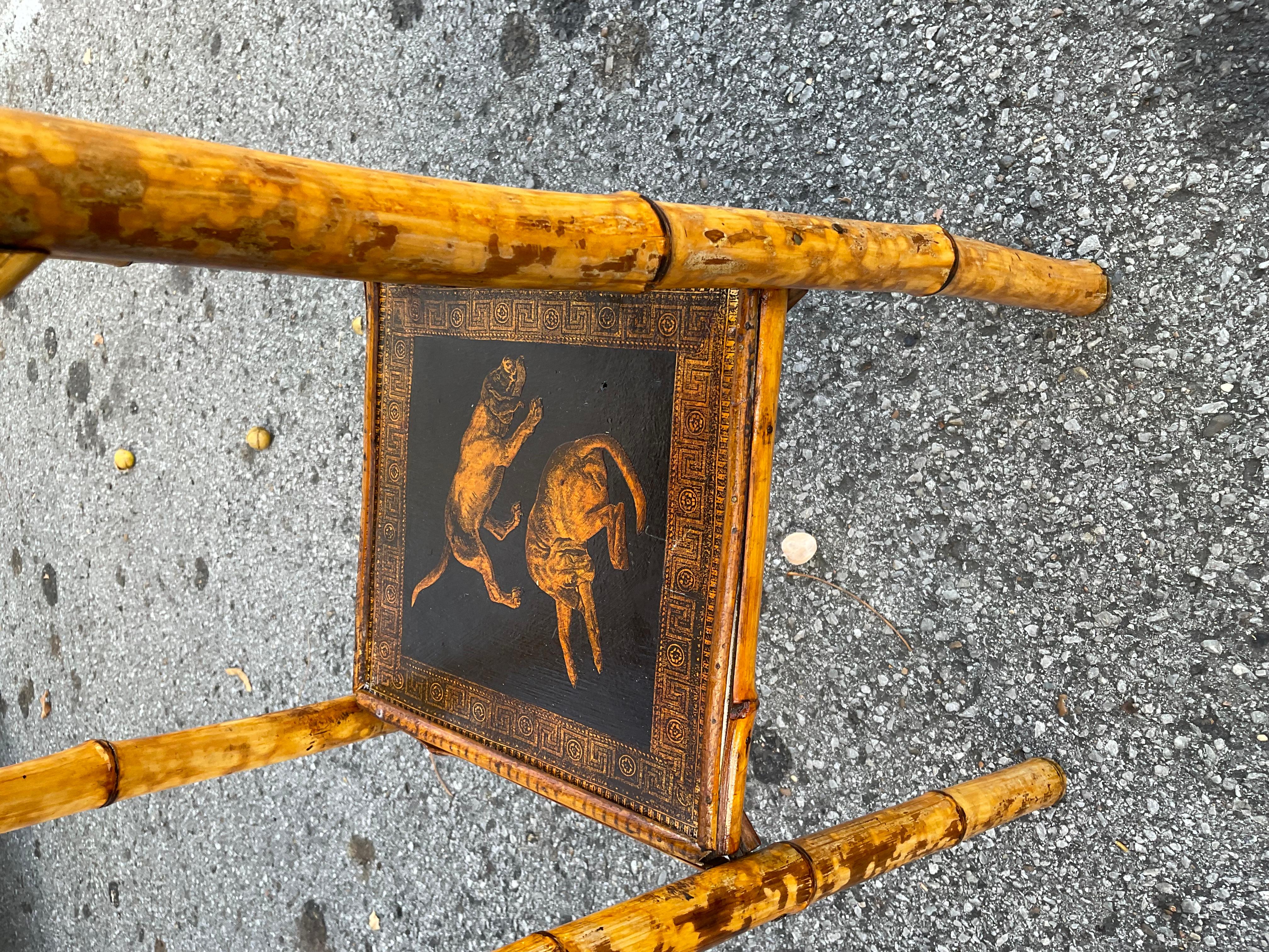 This original 19th century decapodged bamboo side table is simply breathtaking. The beautiful depiction of the dogs, the black and golden color as well as the patina add a warm and unique look to this table that you simply produced anymore. This