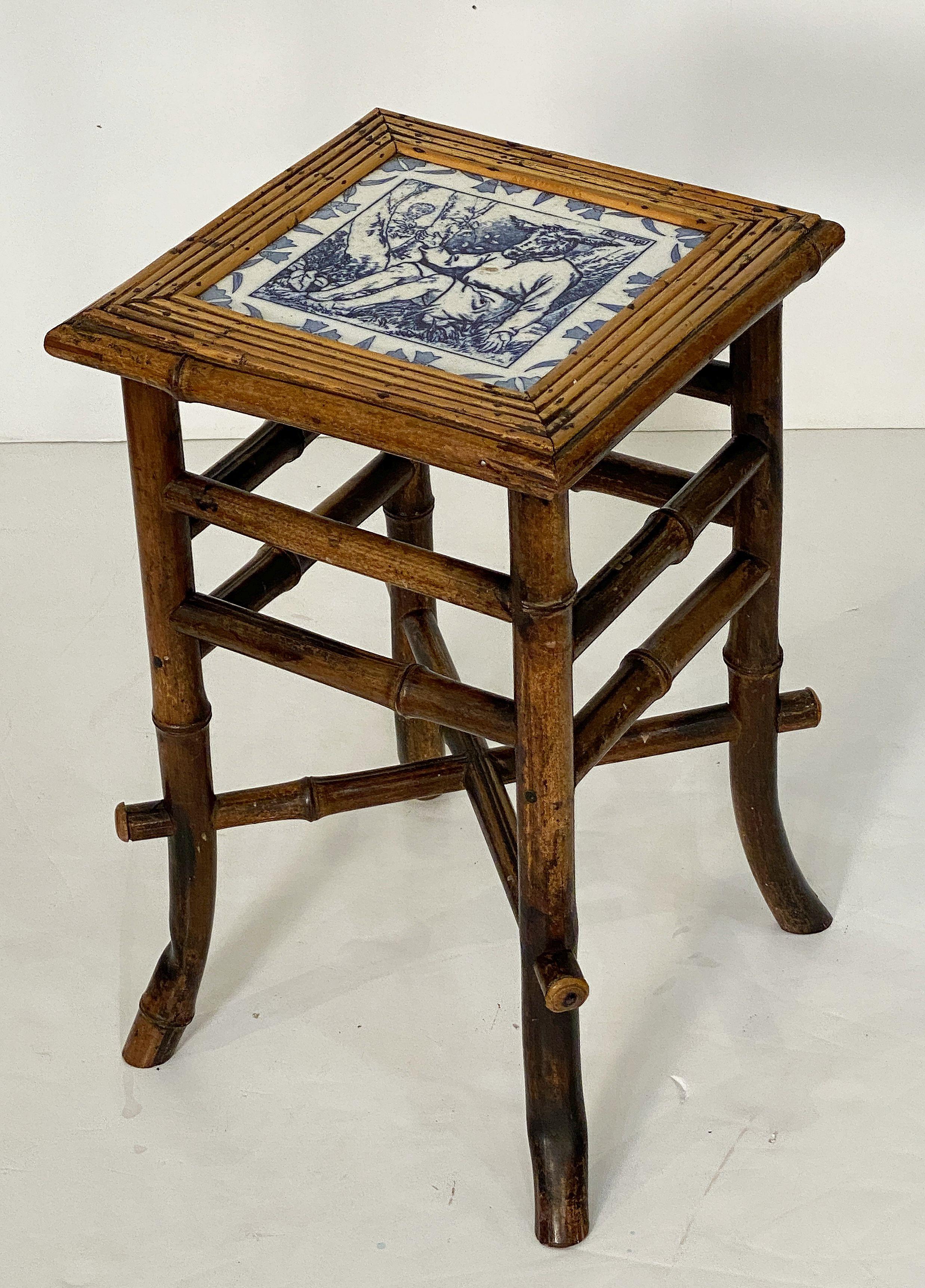 A fine English bamboo table or stool from the Aesthetic Movement period of the late 19th century, featuring a handsome patinated finish and square seat of bamboo with inset blue and white ceramic tile by Wedgwood of the donkey, Nick Bottom, from