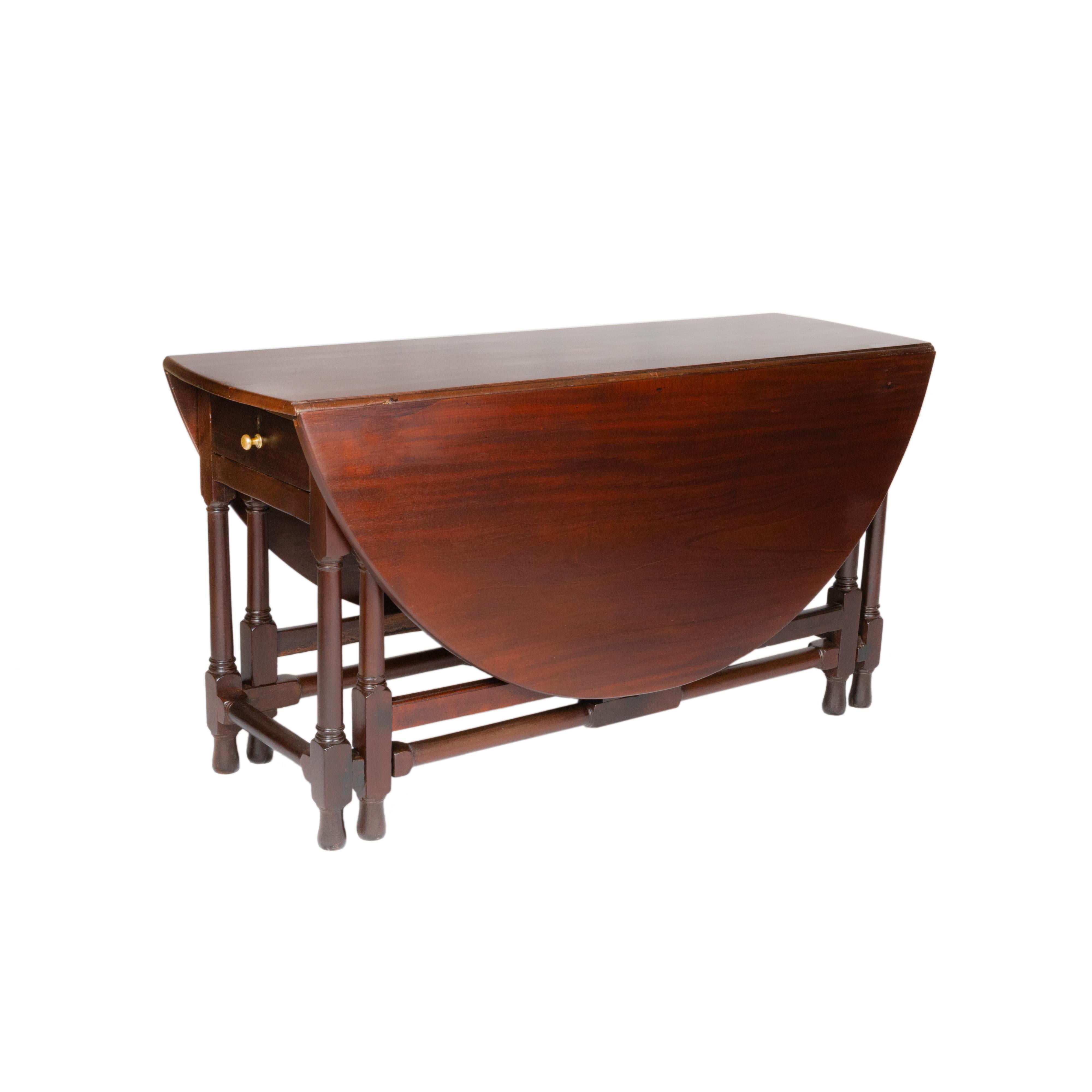 Exquise table de salle à manger de style baroque anglais du XIXe siècle, avec des pieds en forme de porte. 
Cette table se referme dans une forme rectangulaire compacte, mais lorsqu'elle est ouverte, elle se déploie en demi-lune ou en ovale grâce à