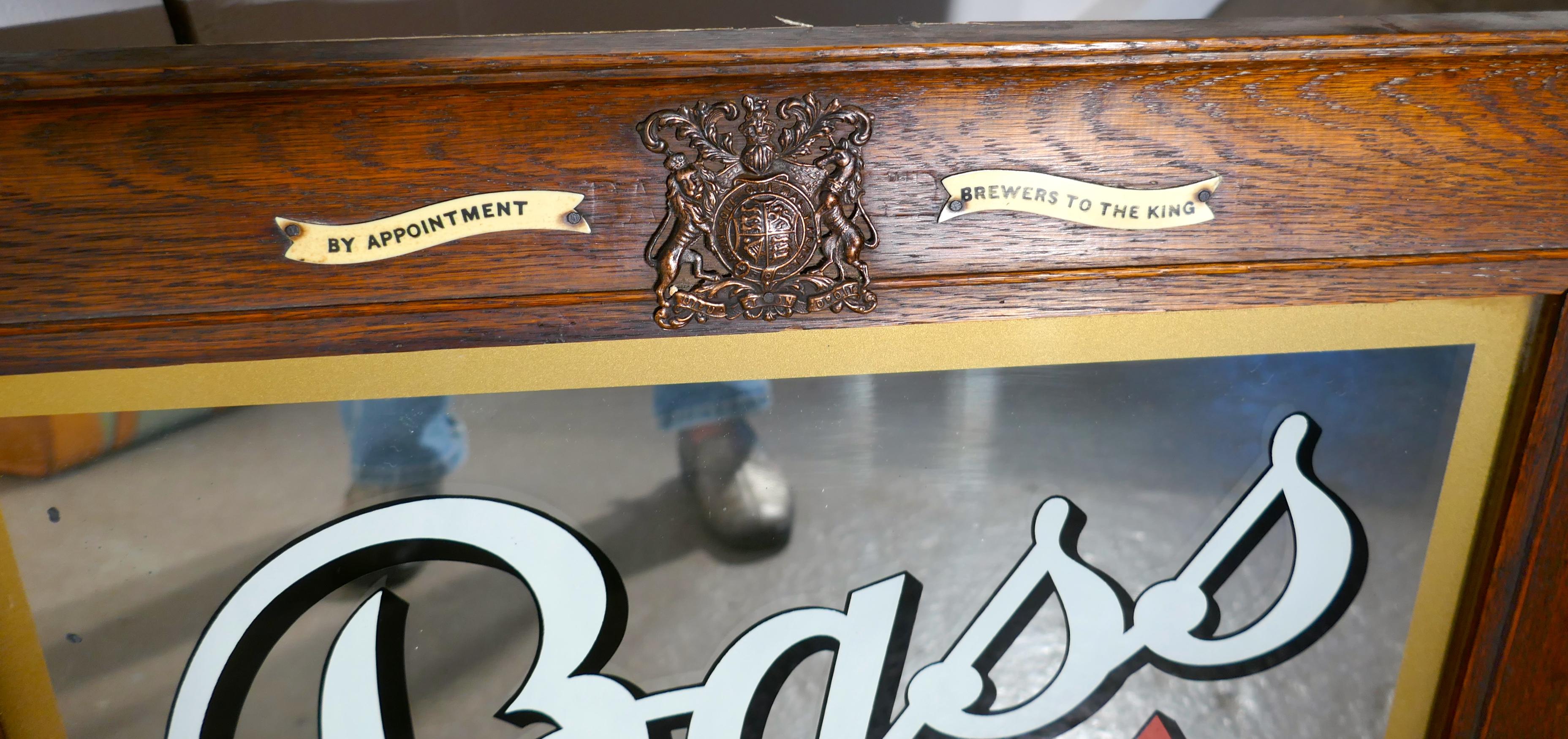 A bass advertising mirror, pub mirror with royal warrant

The mirror has etched and painted lettering advertising bass in bottle 
and of course the iconic logo of the bass red triangle 
 it sits in a moulded 3” wide Oak Frame, at the top of the