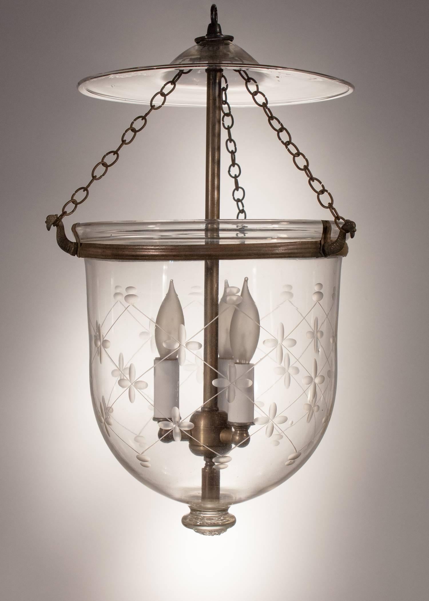 Charming 19th century bell jar lantern from England with an etched trellis pattern and original rolled brass band. This circa 1880 hall lantern features a full and appealing form, and its hand blown glass is of excellent quality. The light has been