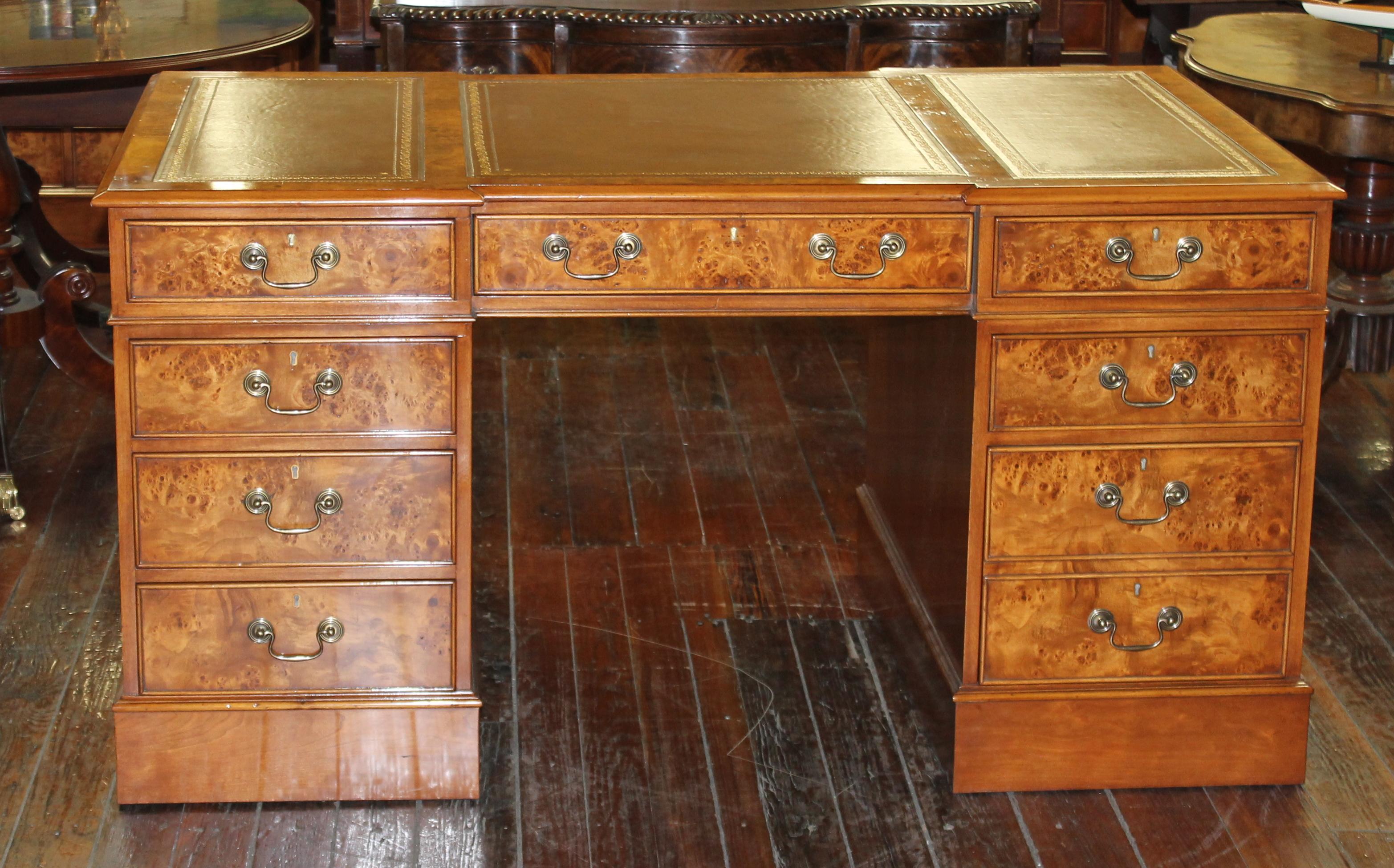 Exceptional quality English bench made reproduction burr elm Chippendale style pedestal partner's desk with hand tooled leather writing surface, made by our own proprietary cabinetmaking firm in the south of England. Made from old parts gleaned from