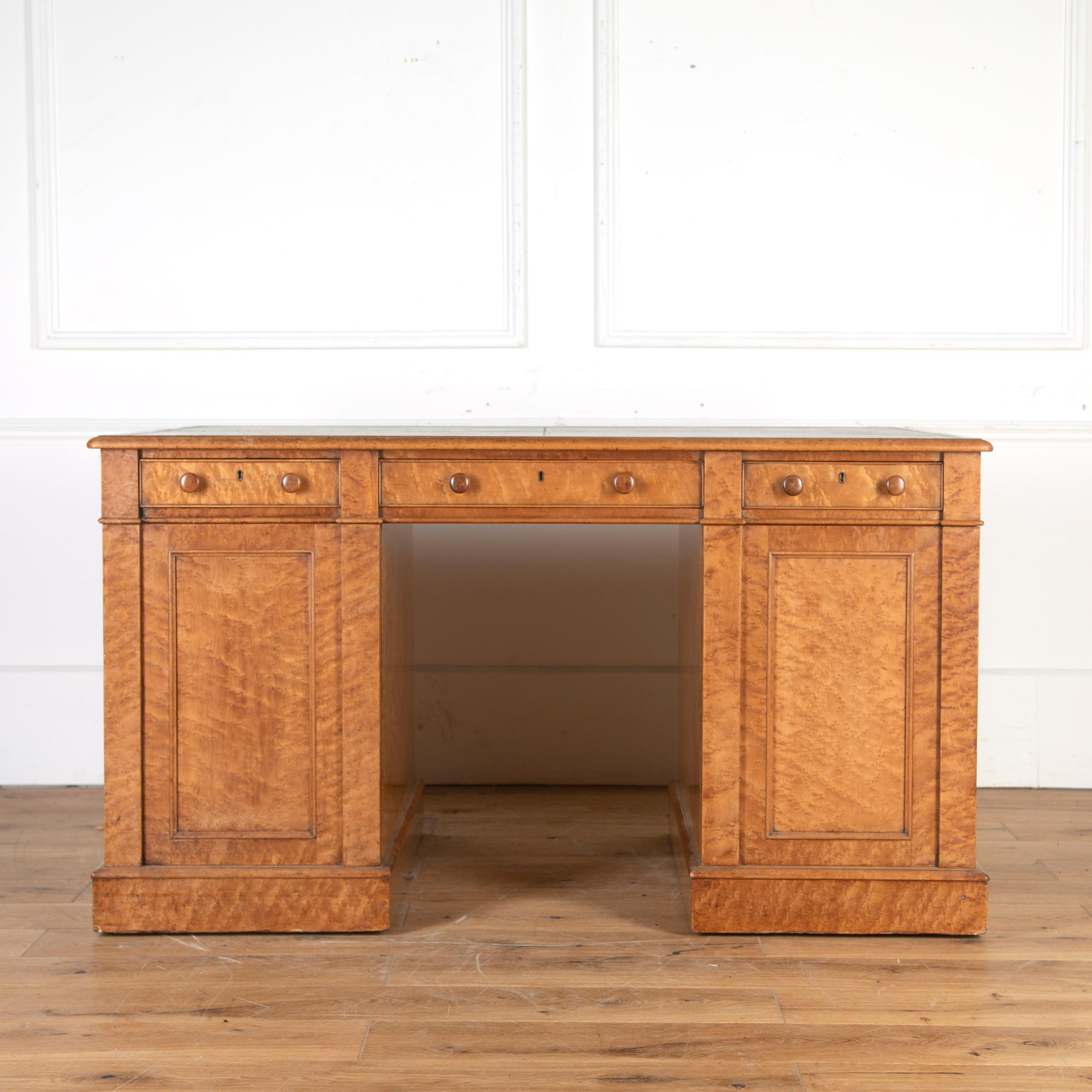 English bird's-eye maple desk, circa 1835. 

This pedestal desk retains its original Moroccan leather top, with fitted internal mahogany drawers across the top and two cupboard doors to each pedestal. 

Beautiful 'bird's-eye' figuring throughout