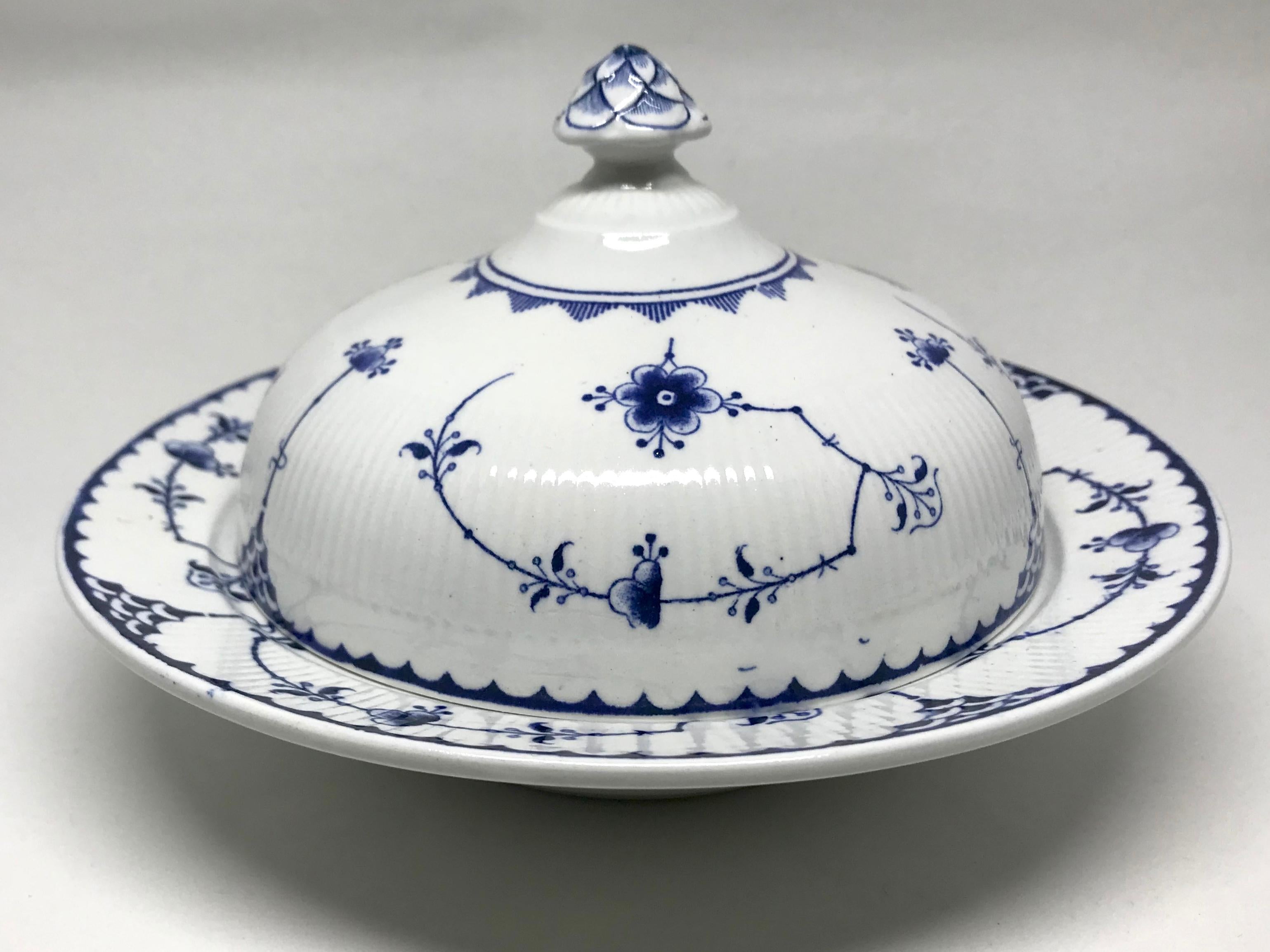 English blue and white covered dish. Blue and white covered dish for butter or cheese with markings for Furnivals Limited. England, early 20th Century
Dimensions: 8” Diameter x 5” H to top of finial; bowl is 2