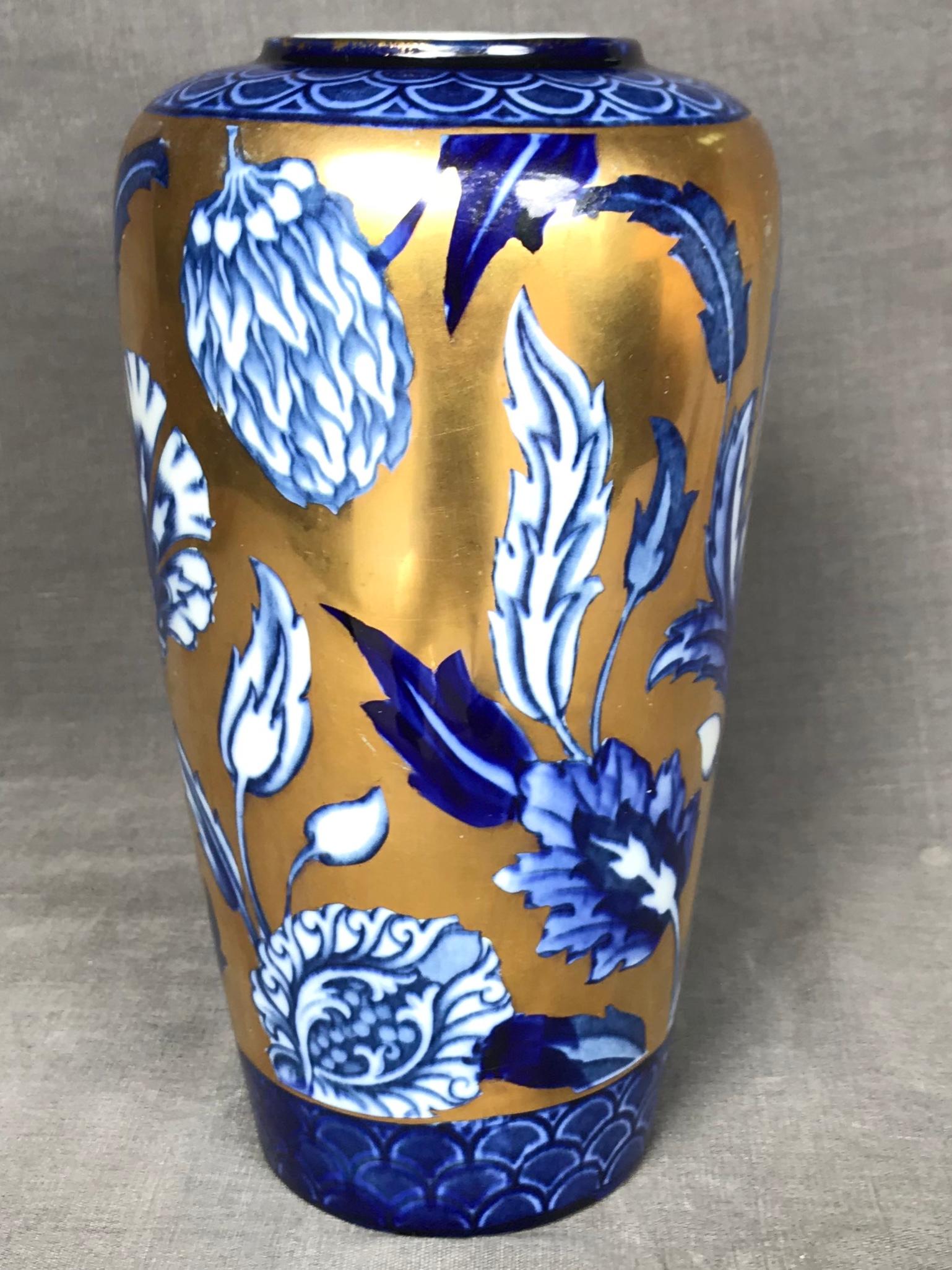 Blue, white and gilt flora vase. Cobalt blue & white floral vase on gilt background with markings for Forrester & Sons, Phoenix Ware in Valencia pattern. England, early 20th century. 
Dimensions: 5