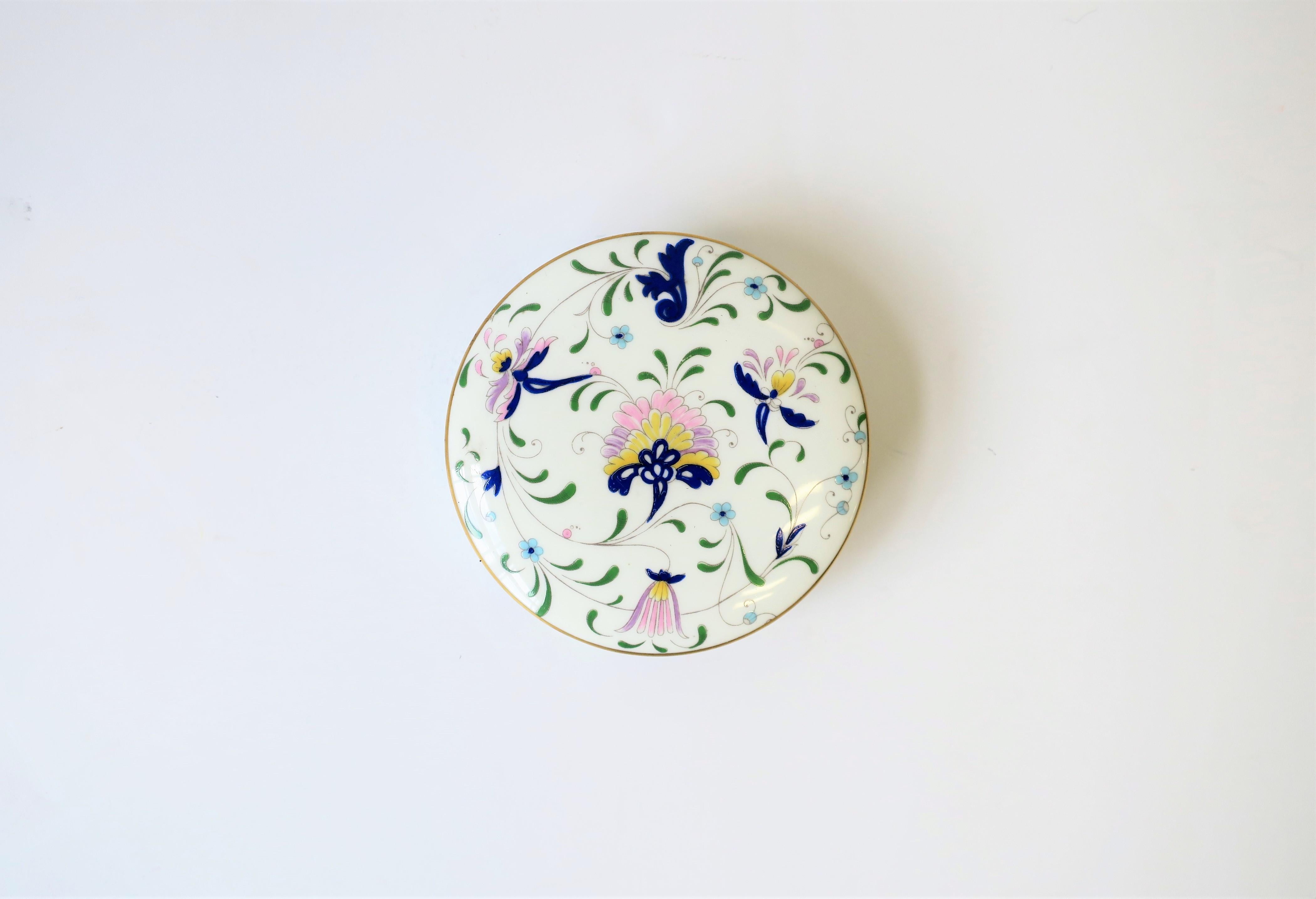 A beautiful English Coalport Porcelain predominantly blue and white 'botanical' decorated round box. Box can hold jewelry other small items. Beautiful floral and leaf design with colors that include: dark blue, light blue, green, yellow, pink, and