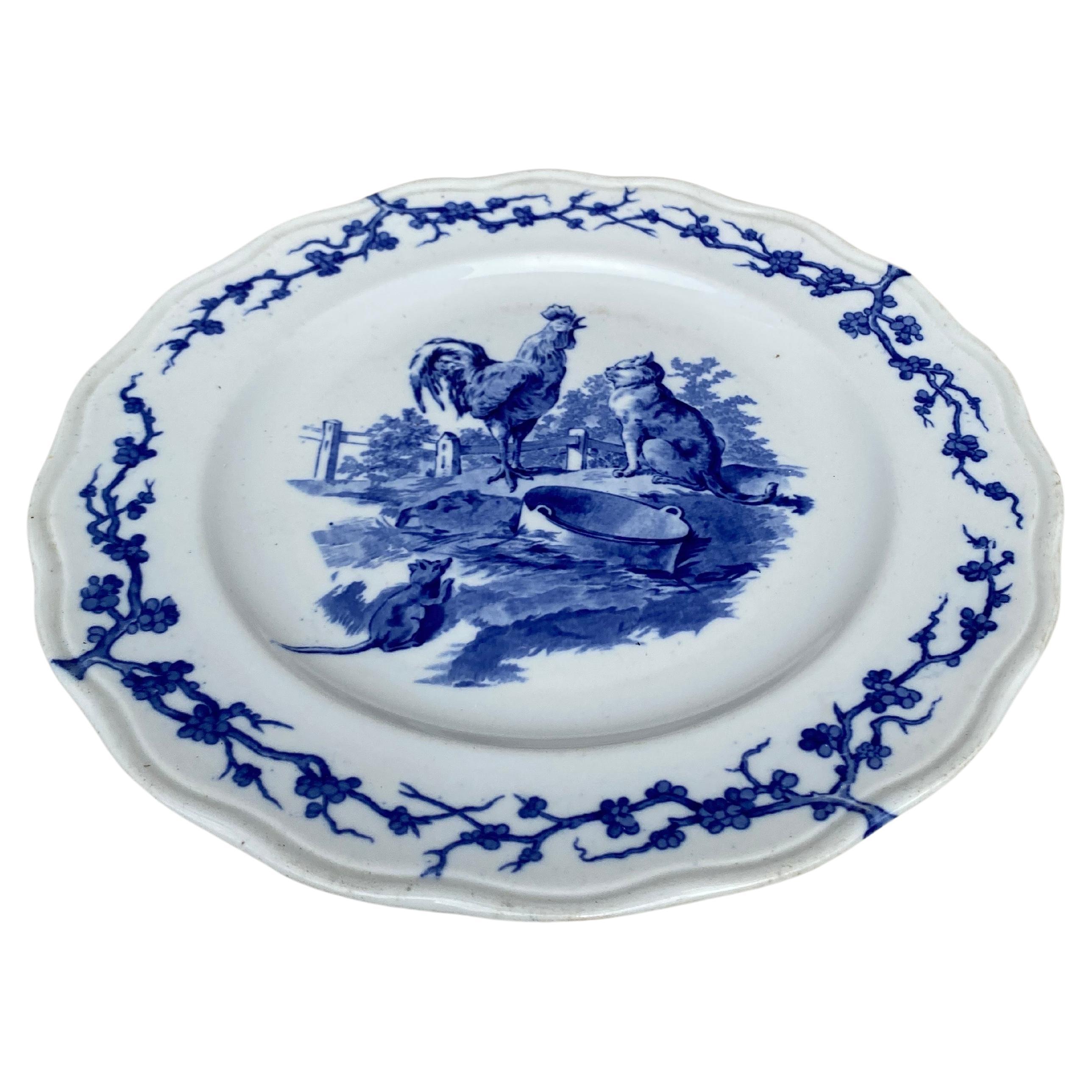 Assiette anglaise bleu et blanc coq et chat Brown Westhead and Moore, vers 1890.
A été vendu au Grand Dépôt 21 rue Drouot Paris.
Fontaine / Fables d'Ésope
Marque de Losange en anglais.