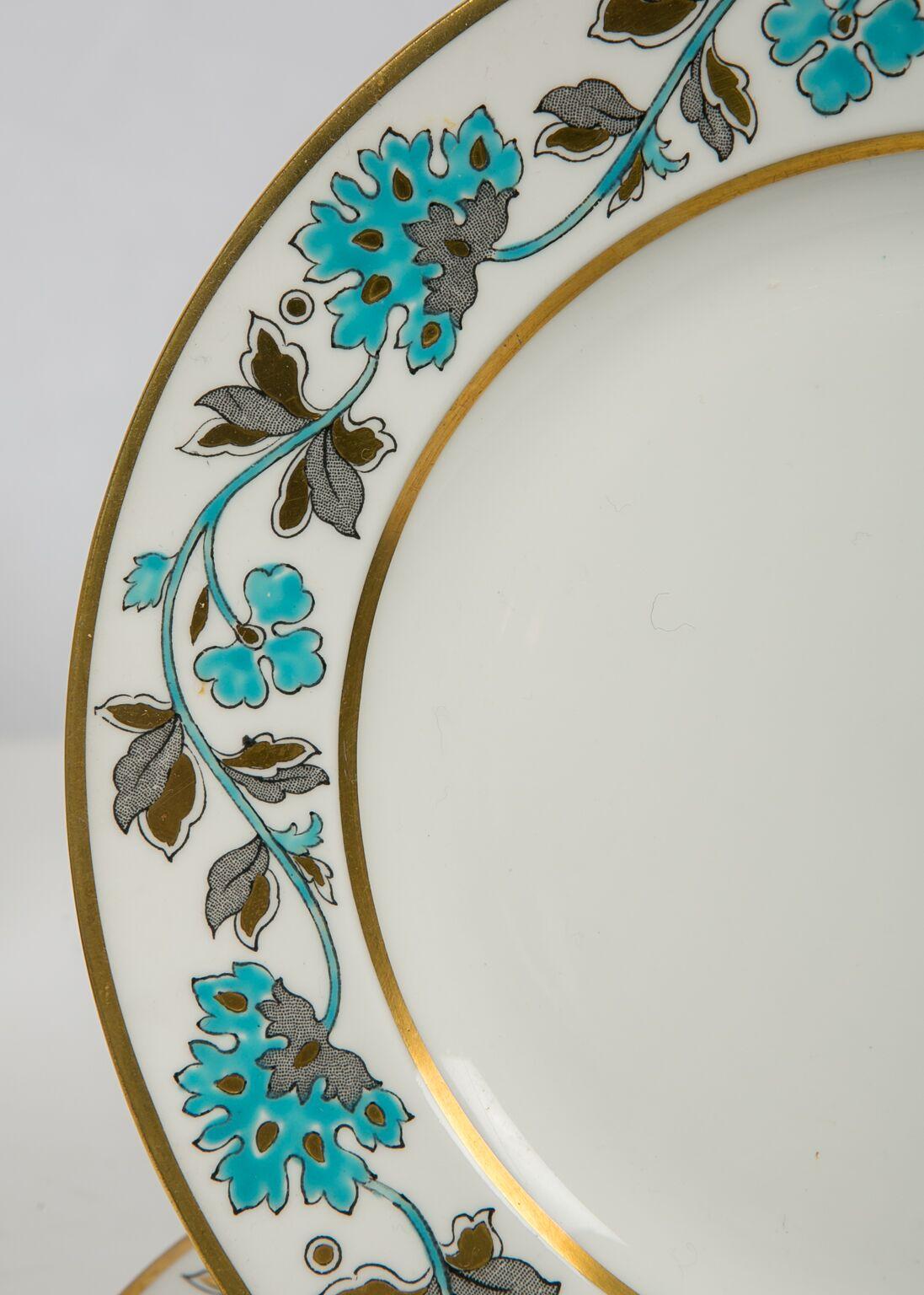 We are happy to offer this charming set of eight plates. They are richly enameled around the border with turquoise peonies, and turquoise, black, and gray leaves. The dishes are made of bone china which is thinner with a smoother glaze, and whiter