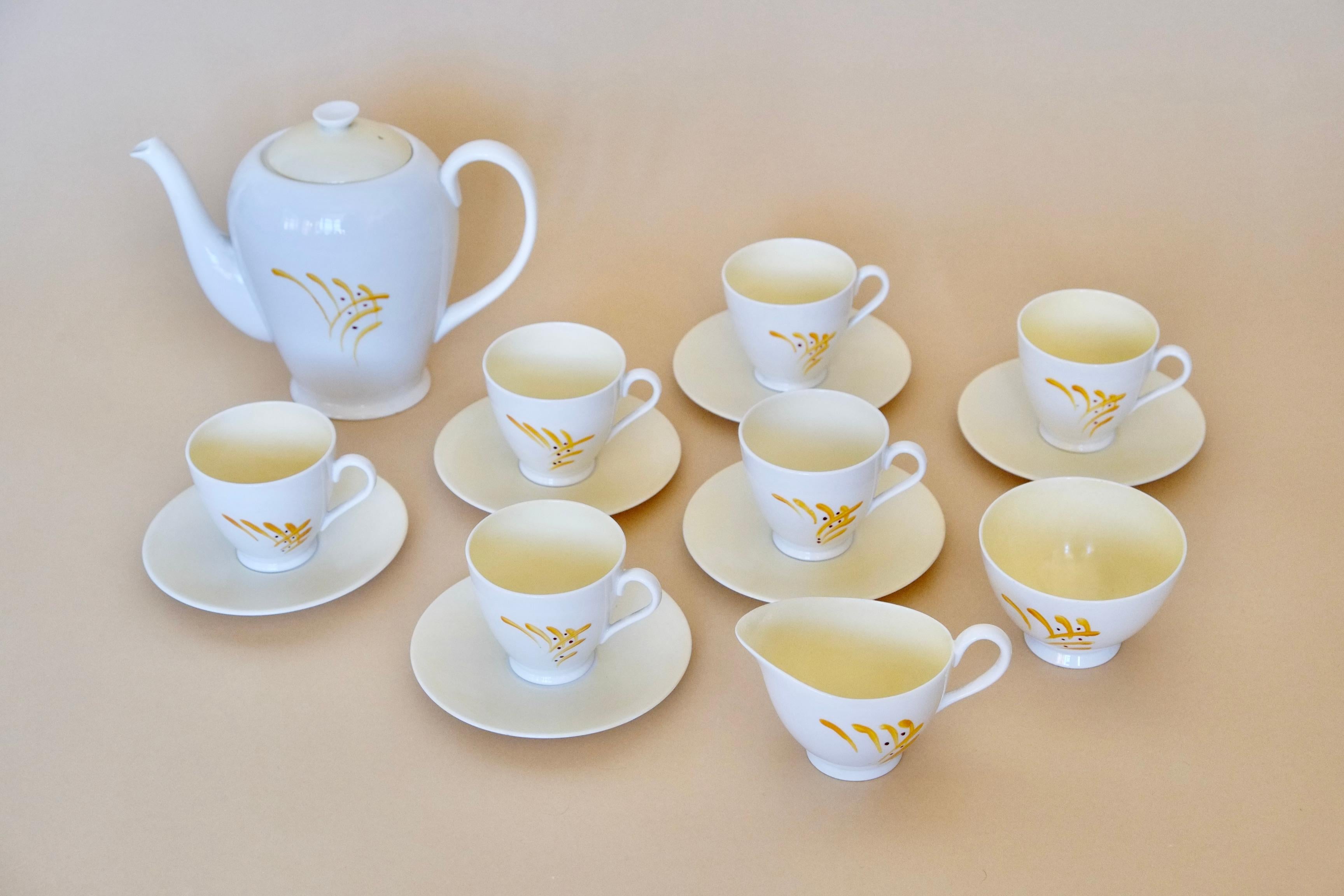 A beautiful midcentury English tea set by Tuscan Fine Bone China
Made in England

This tea set has a beautiful handpainted design with organic brushstrokes in deep yellow and a crisp white ground. The templates, lids and interior is glazed with the