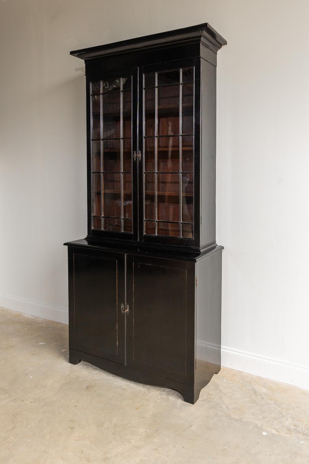 This beautiful early 19th Century English bookcase is glazed and has the original glass and doors with working locks and keys.
