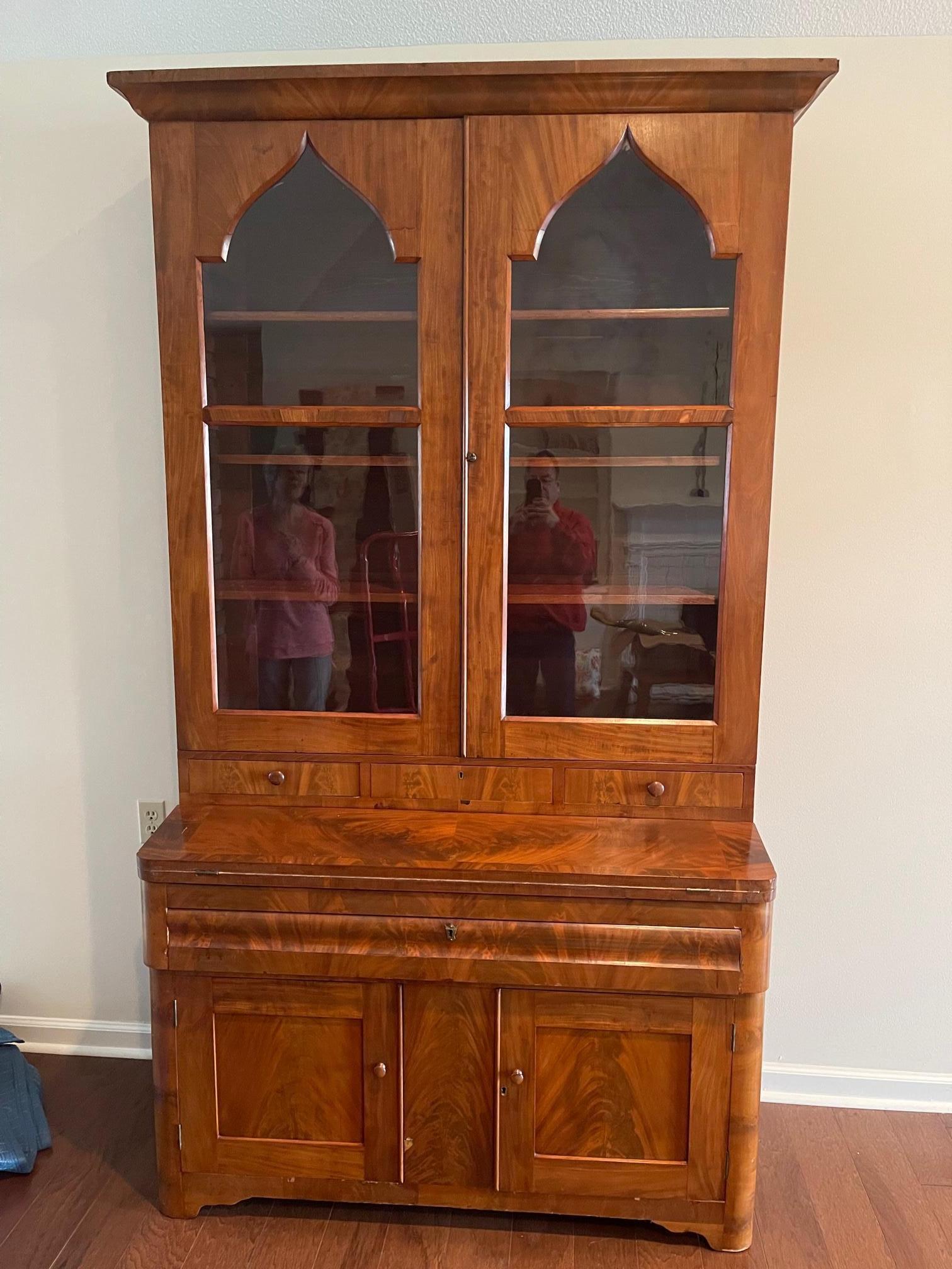 English secretary with glass door and three glass shelves, leather inlay on desk surface, original glass panels, 19th Century. There is one crack on one of the glass panels which we can replace, but would like to give the opportunity to the client