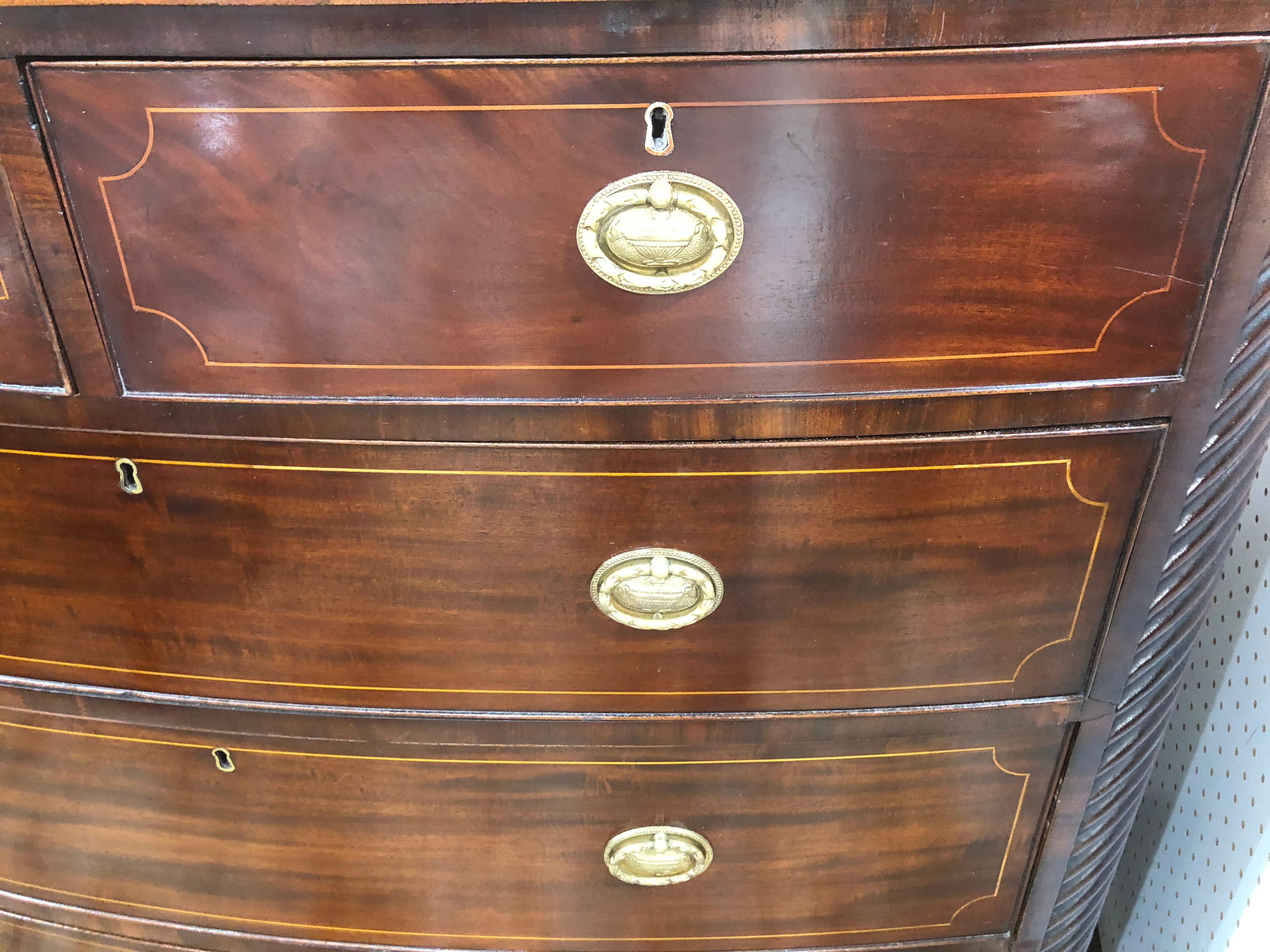 English bow front chest with rope twist edges, line inlay in satinwood on each drawer and top edge, replacement pulls solid brass, and excellent color. Nice bracket feet, drawers work well.