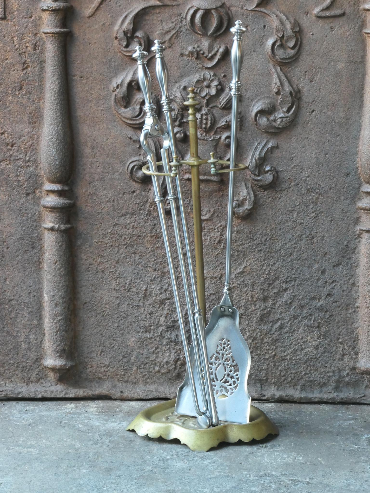Beautiful 18th - 19th century English Georgian fireplace companion set. The tool set consists of tongs, shovel, poker and stand. All with fine decorations. The tools are made from polished steel. The stand is made from brass. The set is in a good