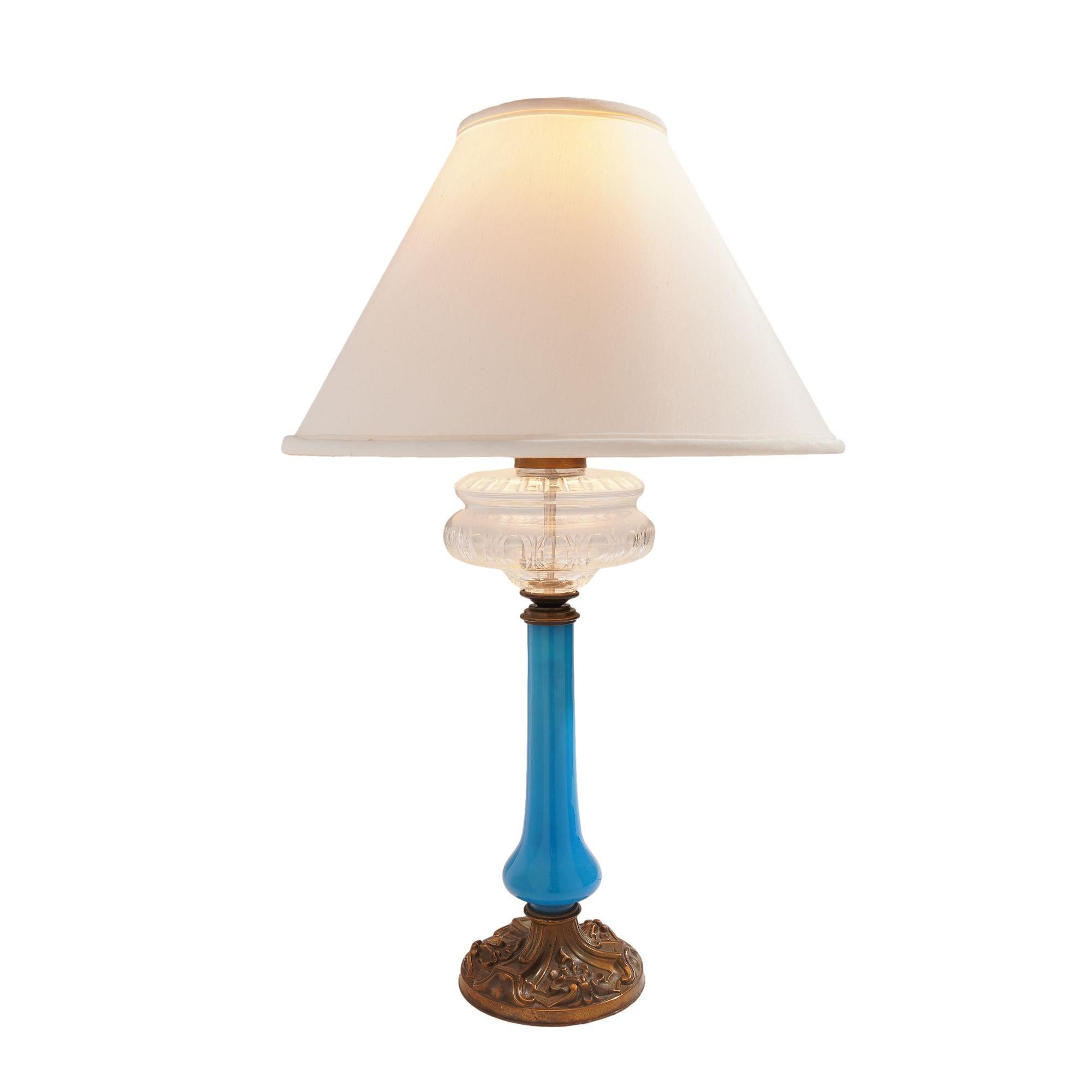 Stunning blue opaline glass oil lamp mounted on a brass base and fitted with a slice cut clear crystal glass font. The lamp has been converted from oil and electrified. Sold without shade.

Bristol, England, circa 1850.

Dimensions: 7