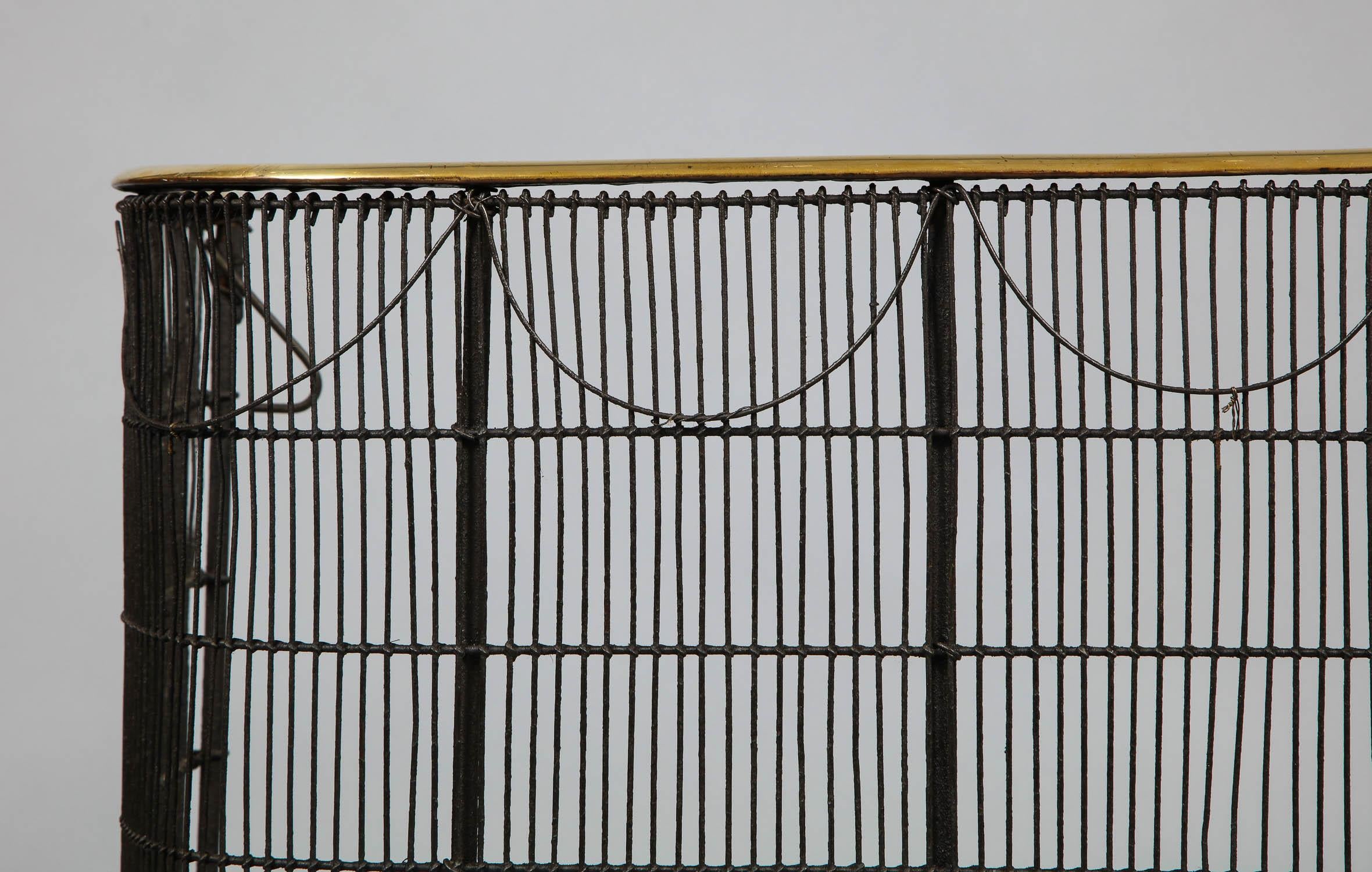 Fine mid-19th century English brass and iron fire screen or nursery guard having half round brass rail over wrought iron framework with iron wire mesh having swag decoration, retaining original hooks and mounting pinions.