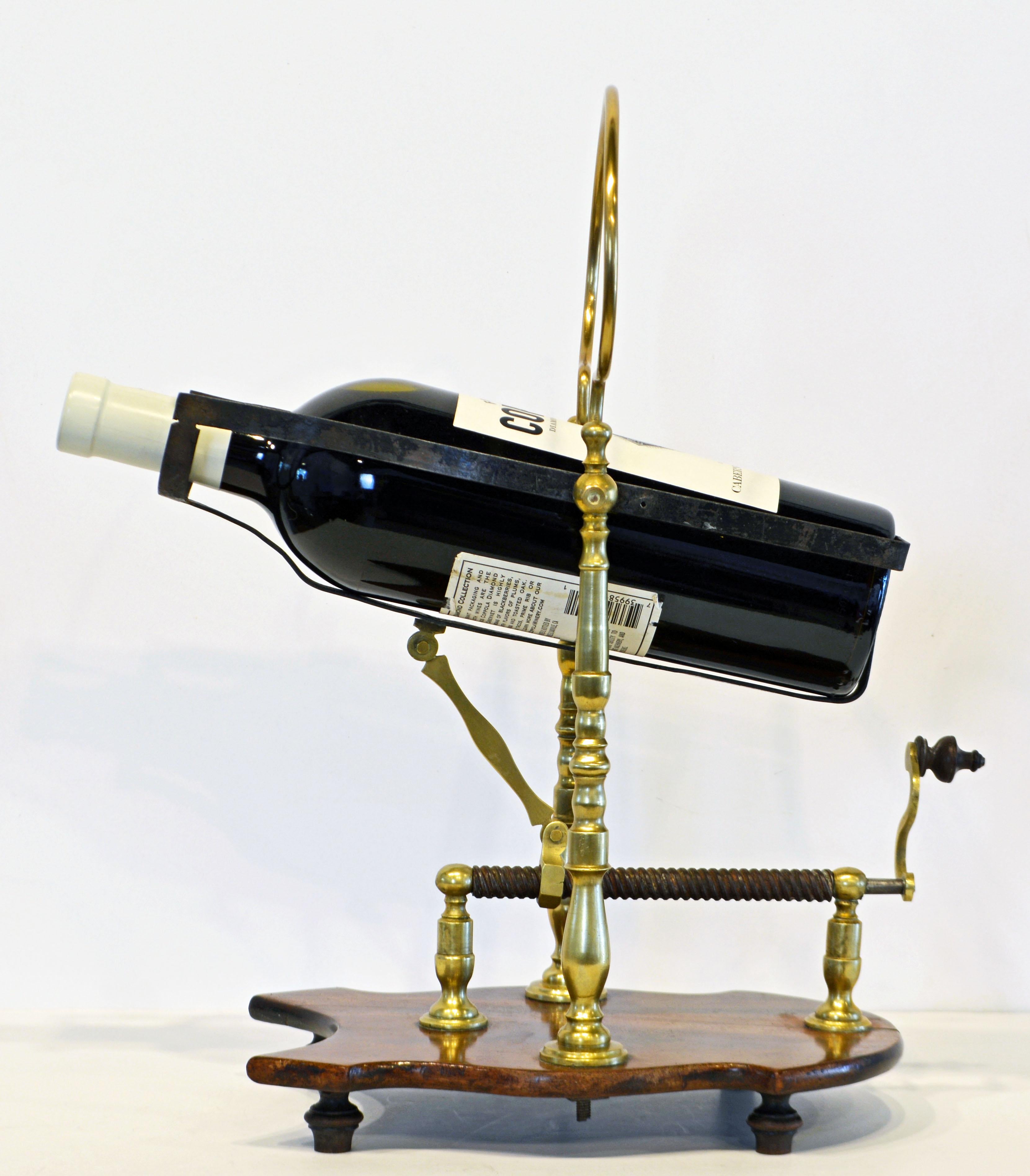 This ingenious device dating to circa 1890 holds a 750 ml bottle in a cradle attached to an adjustable spindle turning handle. It is mounted on a shaped mahogany base on four turned feet. The cradle serves the purpose of decanting a vintage Port,