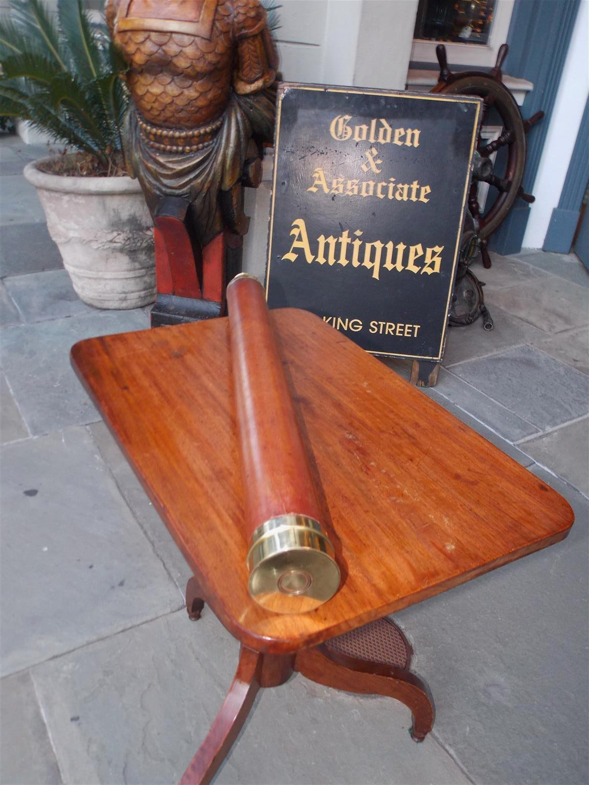 English brass and wood barrel nautical ship captain's spyglass with a single draw, polished sunshade, lense cap, and engraved focal tube by maker James Chapman St. Catherines Dock, London.  Mid-19th century. Spyglass is in working condition with