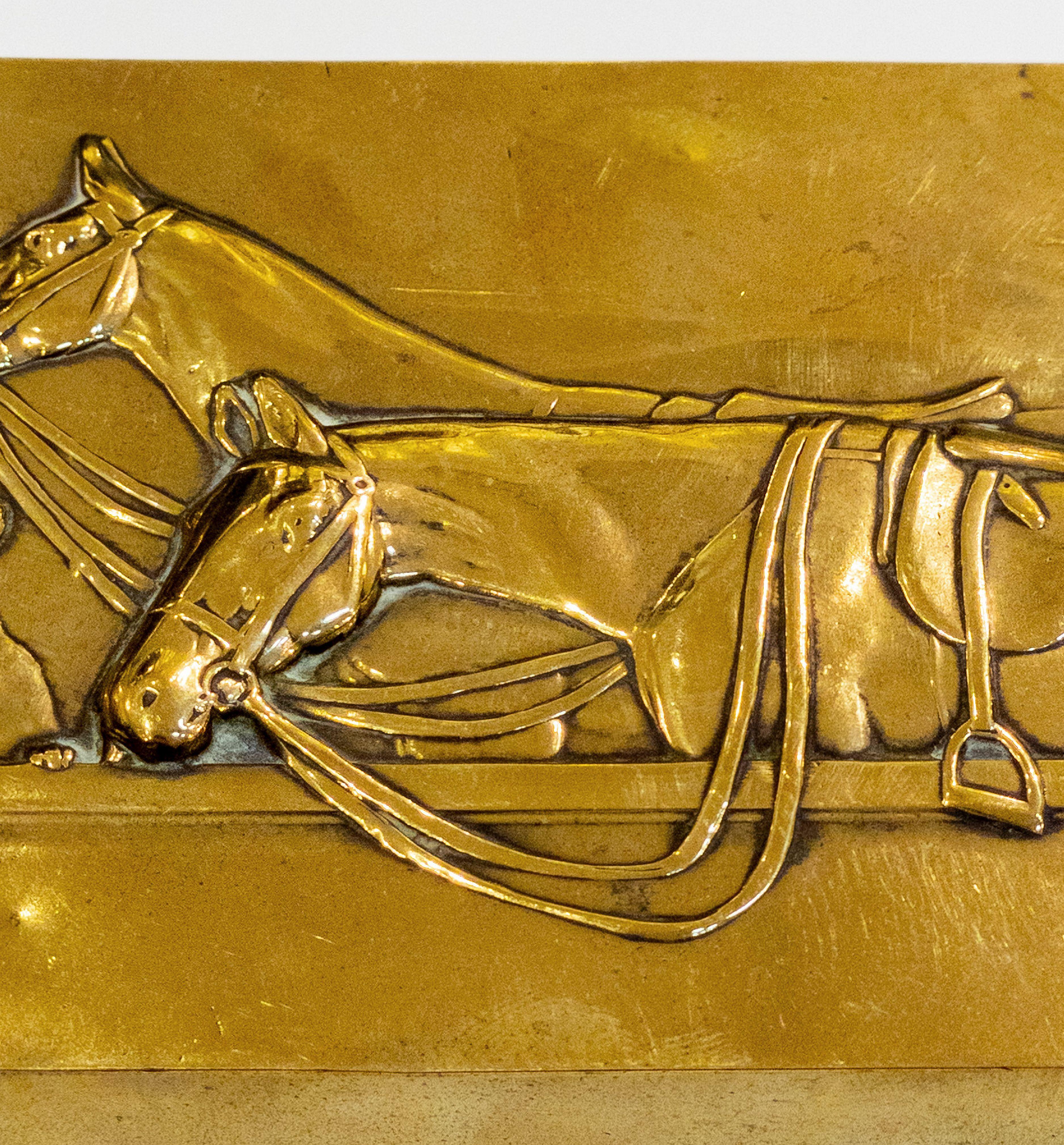 A fine English wood-lined brass cigarette or tobacco box, featuring an embossed lid with a scene of two horses with a hound or dog.
