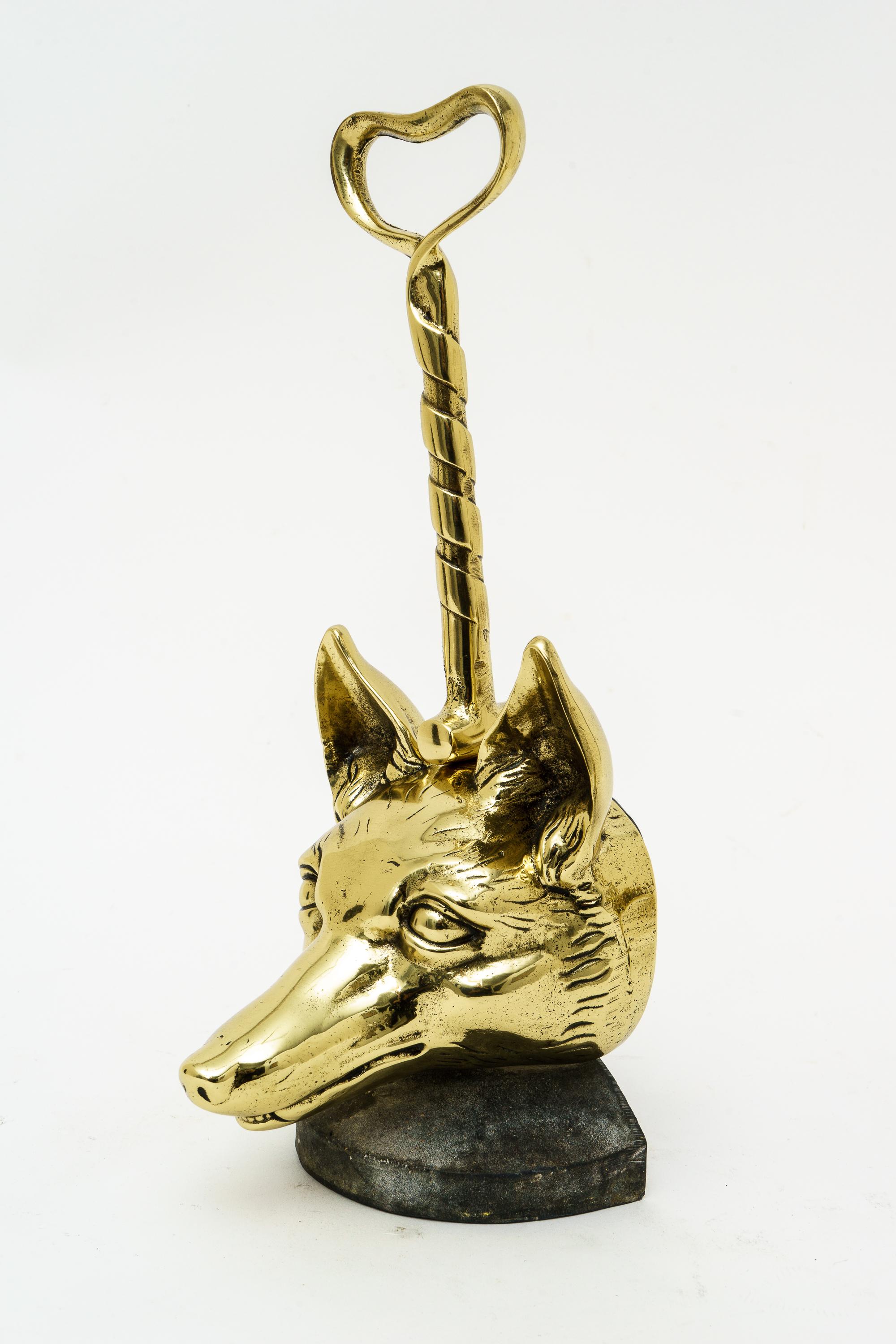 Delightful 1920s English door stop. Polished brass fox head with riding crop, professionally polished and lacquered. Measures: 13