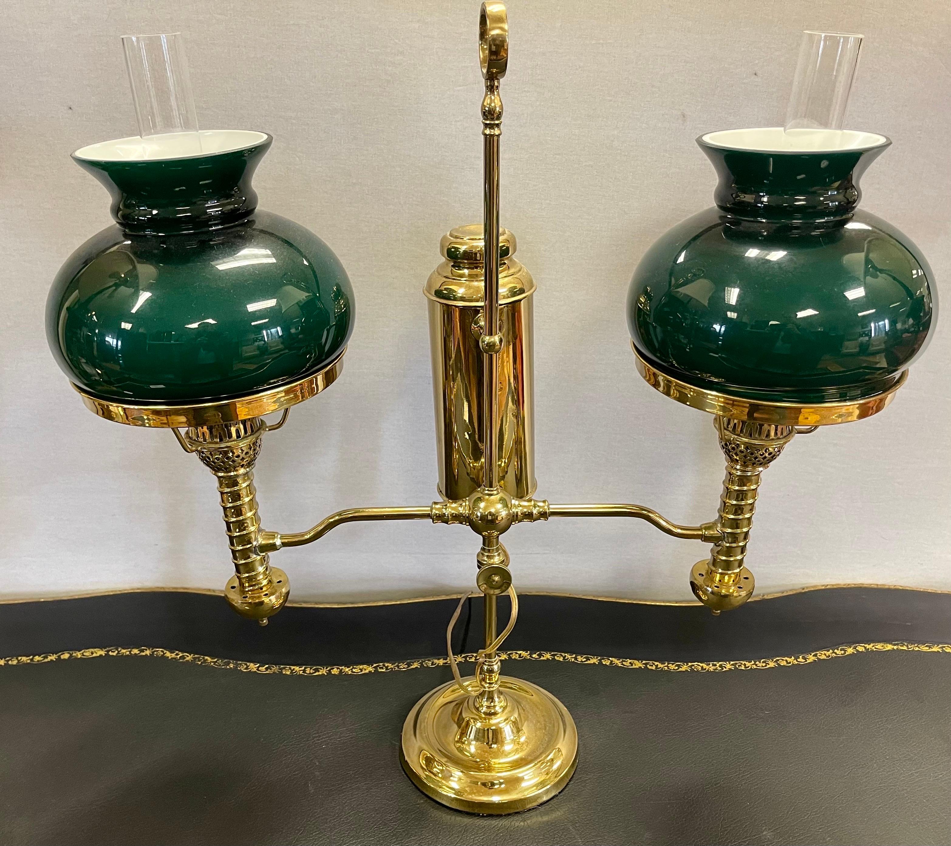 English Victorian style brass adjustable double arm student lamp with Masters green glass shades. Fully electrified and in working order. Wired for USA. Why not own the best!.