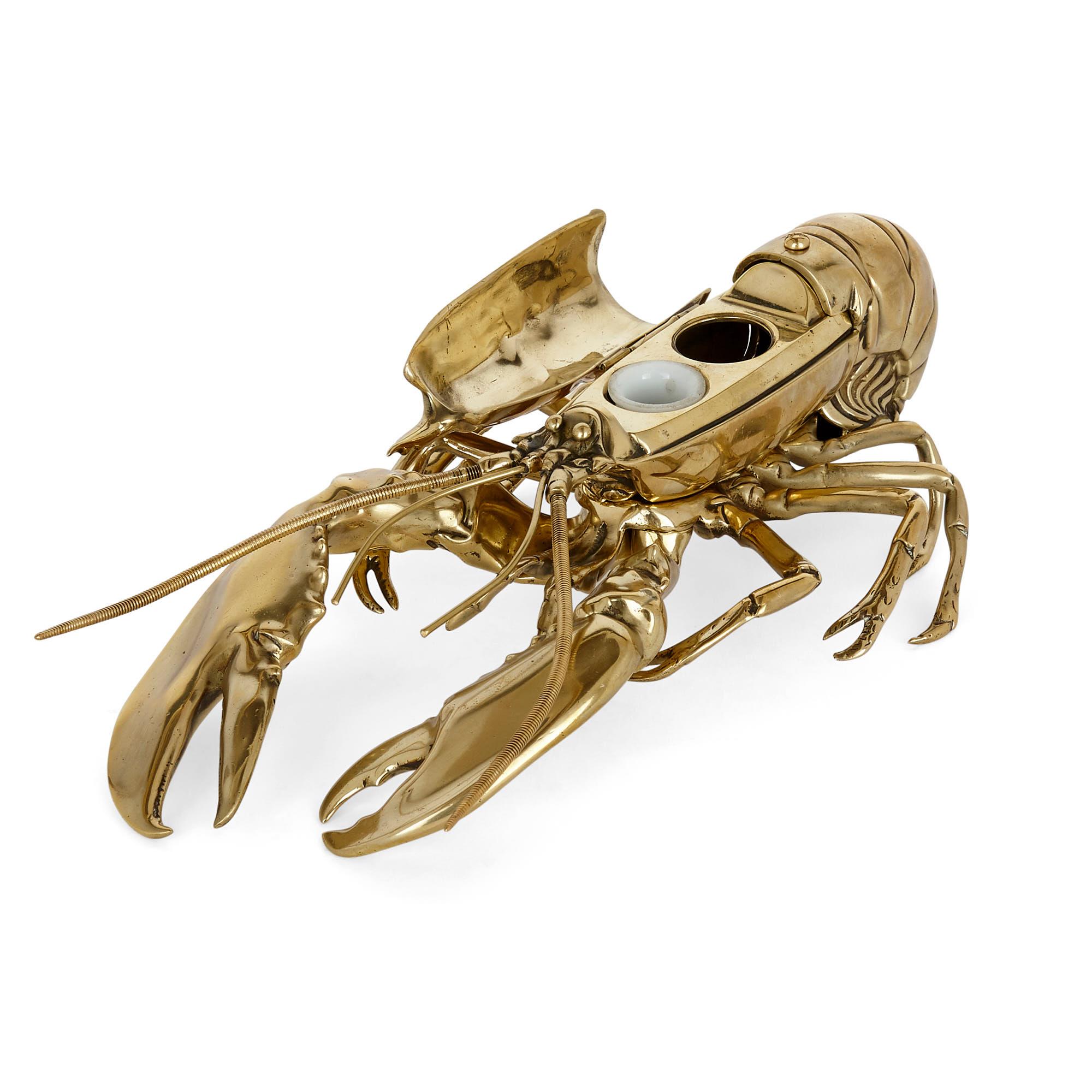 English brass inkwell in the form of a lobster
English, late 19th century
Measures: Height 9.5cm, width 17.5cm, depth 33cm

This bizarre yet charming brass inkwell takes the guise of a lobster. The lobster contains two inkwells, set beneath a