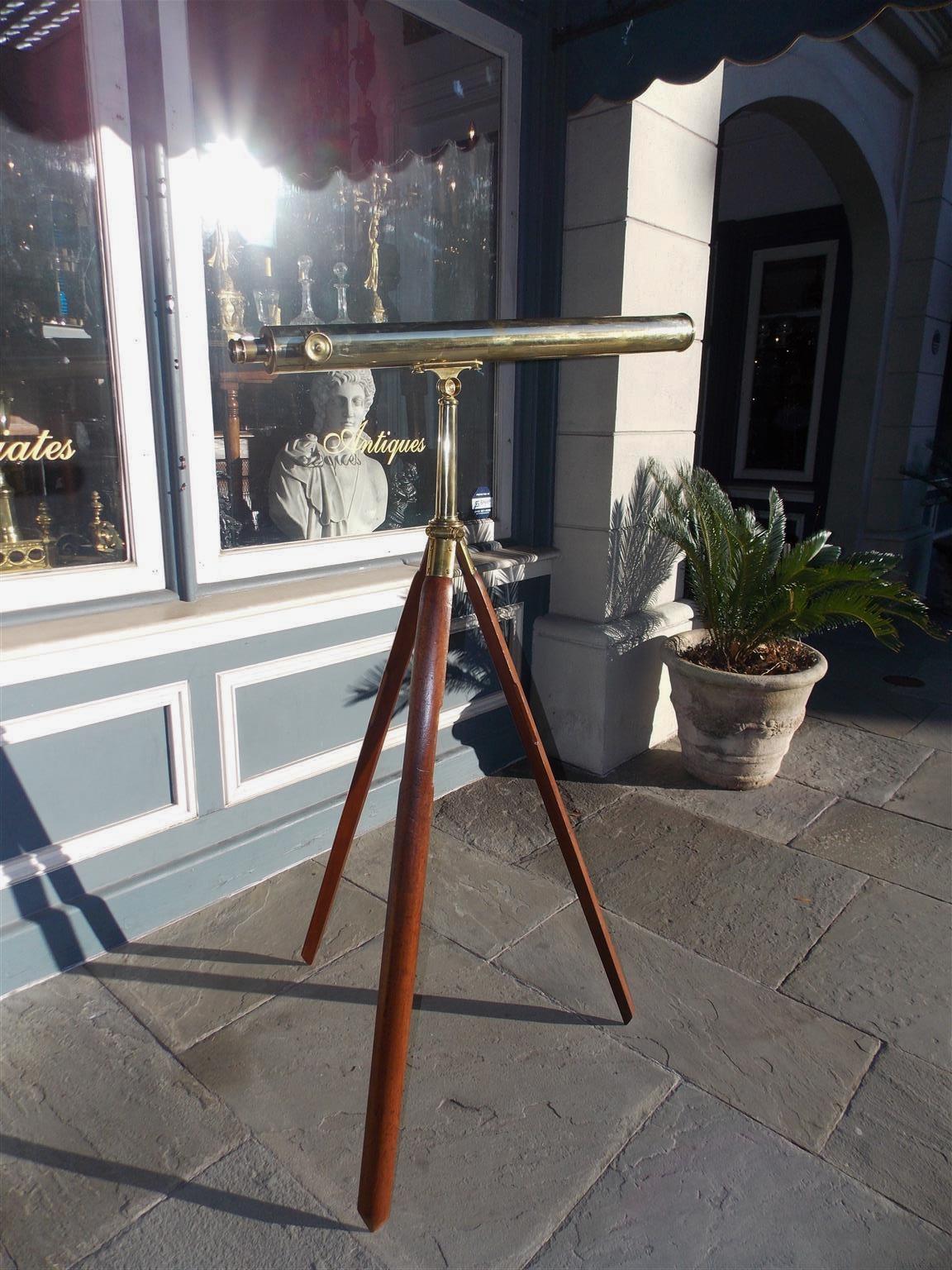 English British colonial telescopic brass-mounted telescope on walnut tripod stand with the original carrying case. Telescope is in working condition, Late 19th century.
