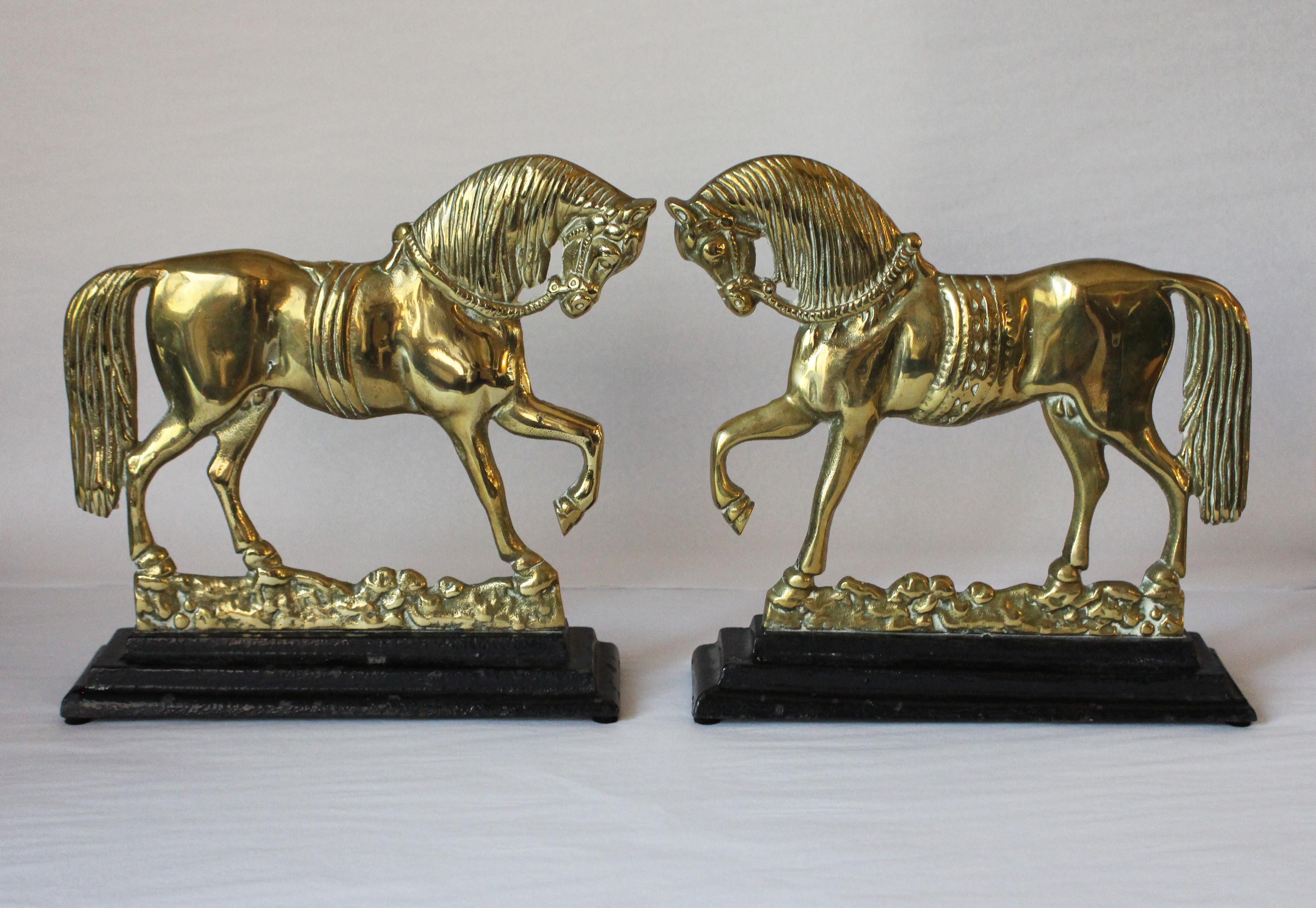 Late 19th-early 20th century pair of trotting horse chimney ornaments, brass on iron stepped bases, very well molded, cast and detailed. English. Ideal as bookends, doorstops, or decoration.

We have been a major source for the selective buyer for