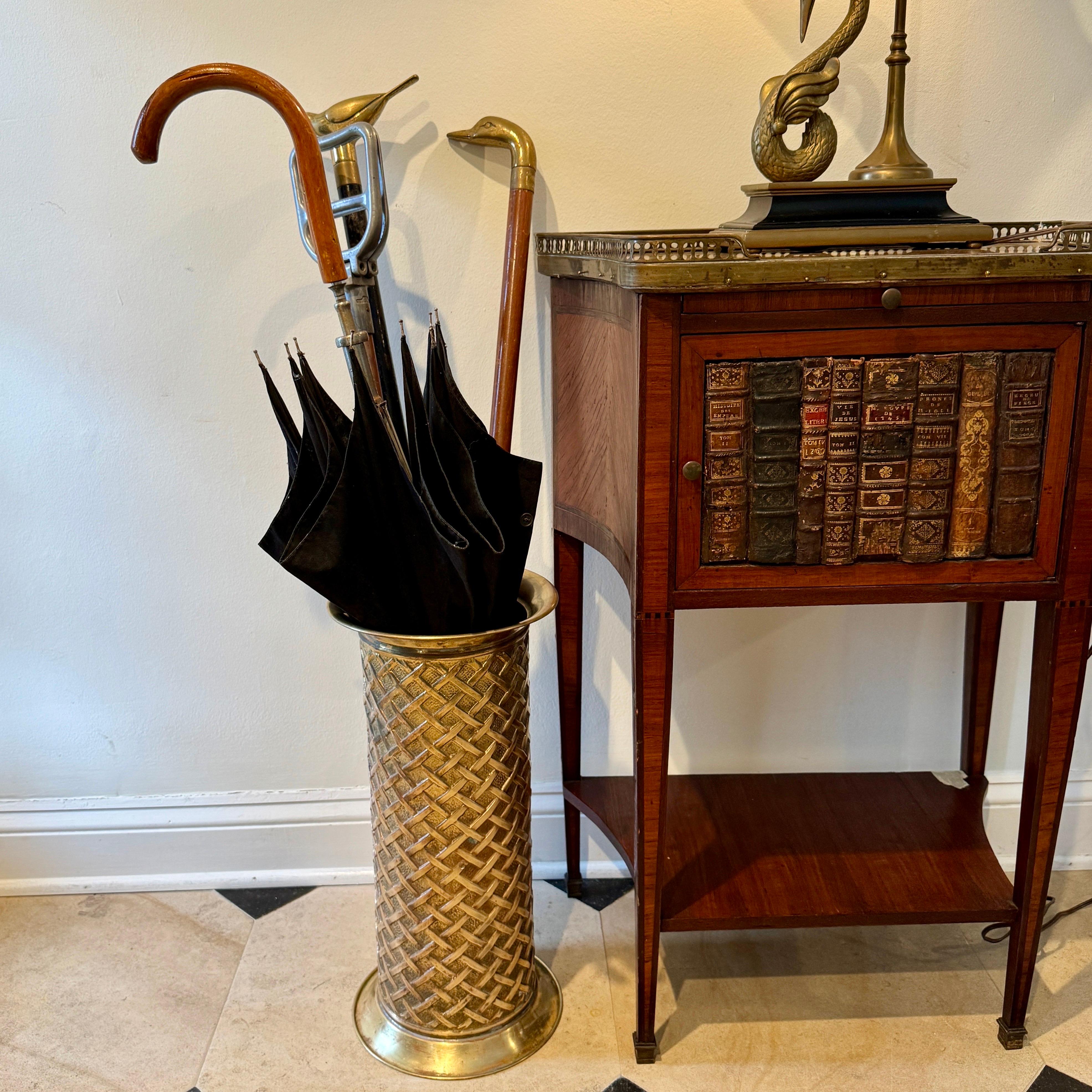 1950's Brass Metal Umbrella and Canes Stand by Lombard England Brass

The finishing touch for your well-appointed home, this vintage umbrella stand makes an essential addition to your entryway. Beautiful pressed brass stand with a basketweave, criss