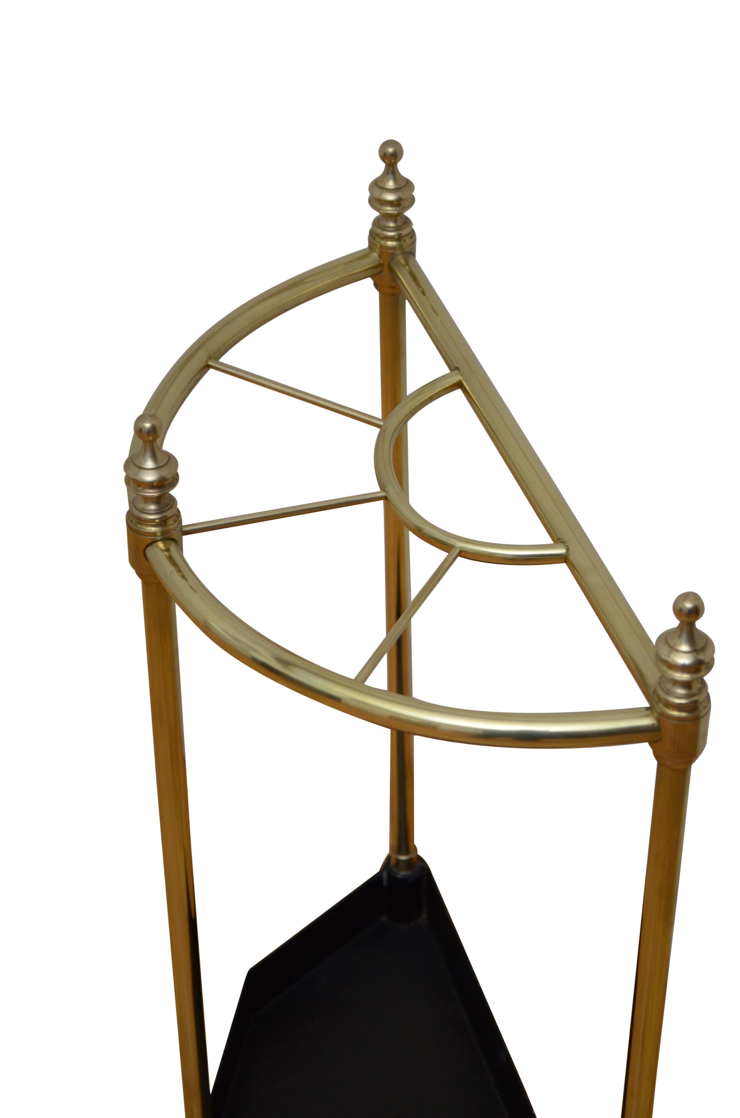 0251 English vintage brass umbrella stand or walking stick stand, having five compartments, three decorative finials and canted drip tray. This antique umbrella stand has been cleaned and polish and is in home ready condition. c1940 
UK mainland