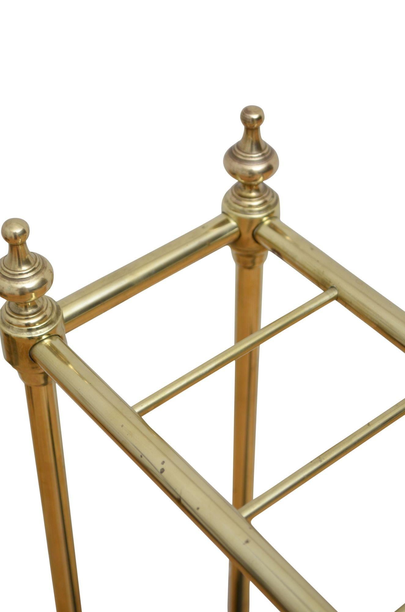 K0258 An English umbrella stand in brass with six divisions flanked by decorative finials and cast iron drip tray with dogtooth decoration to front and sides.. This antique umbrella stand retains its original lacquer, patina and character, all in