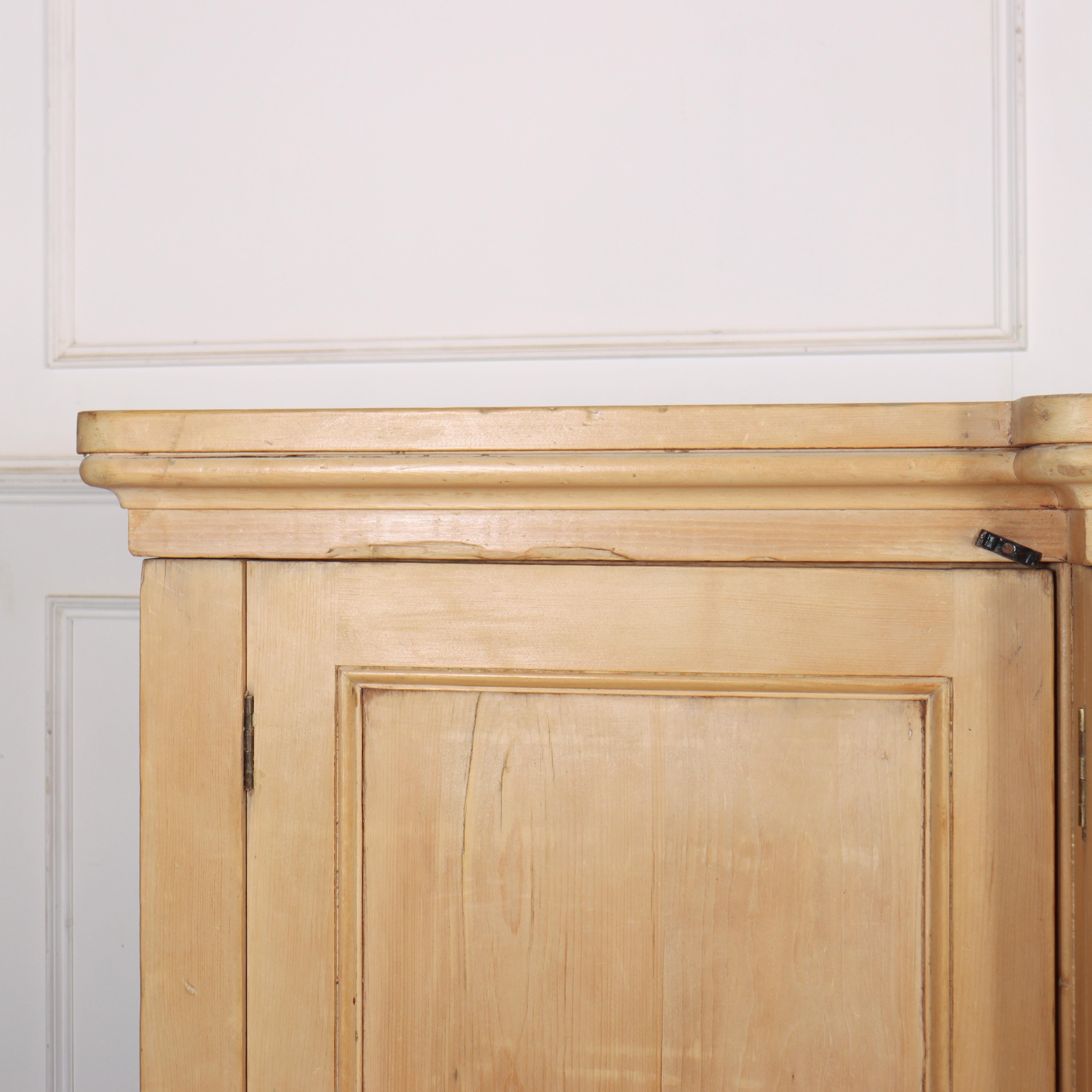 Large early 19th century English breakfront pine linen cupboard with sliding trays to the centre, shelves and a hanging rail. 1830. 

Splits into five pieces for transport and delivery. 


Code: 8949

Dimensions:
W: 99.5
