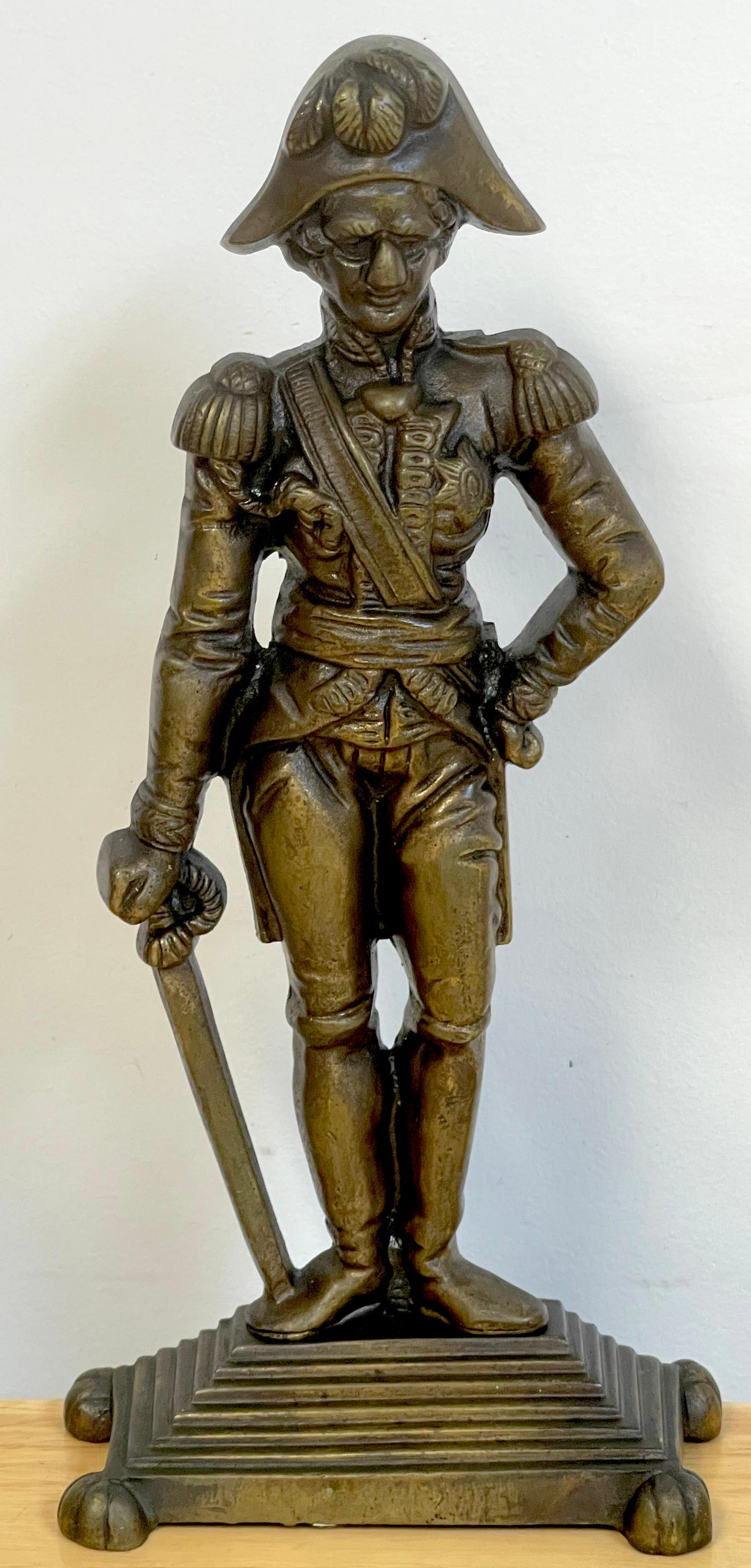 English bronze doorstop of Horatio Lord Nelson, after E. H. Baily, R.A
A fine and rare example of a standing the admiral in full military dress, his right arm resting on a sword, on stepped base. After the E.H. Baily, sculpture. 
 