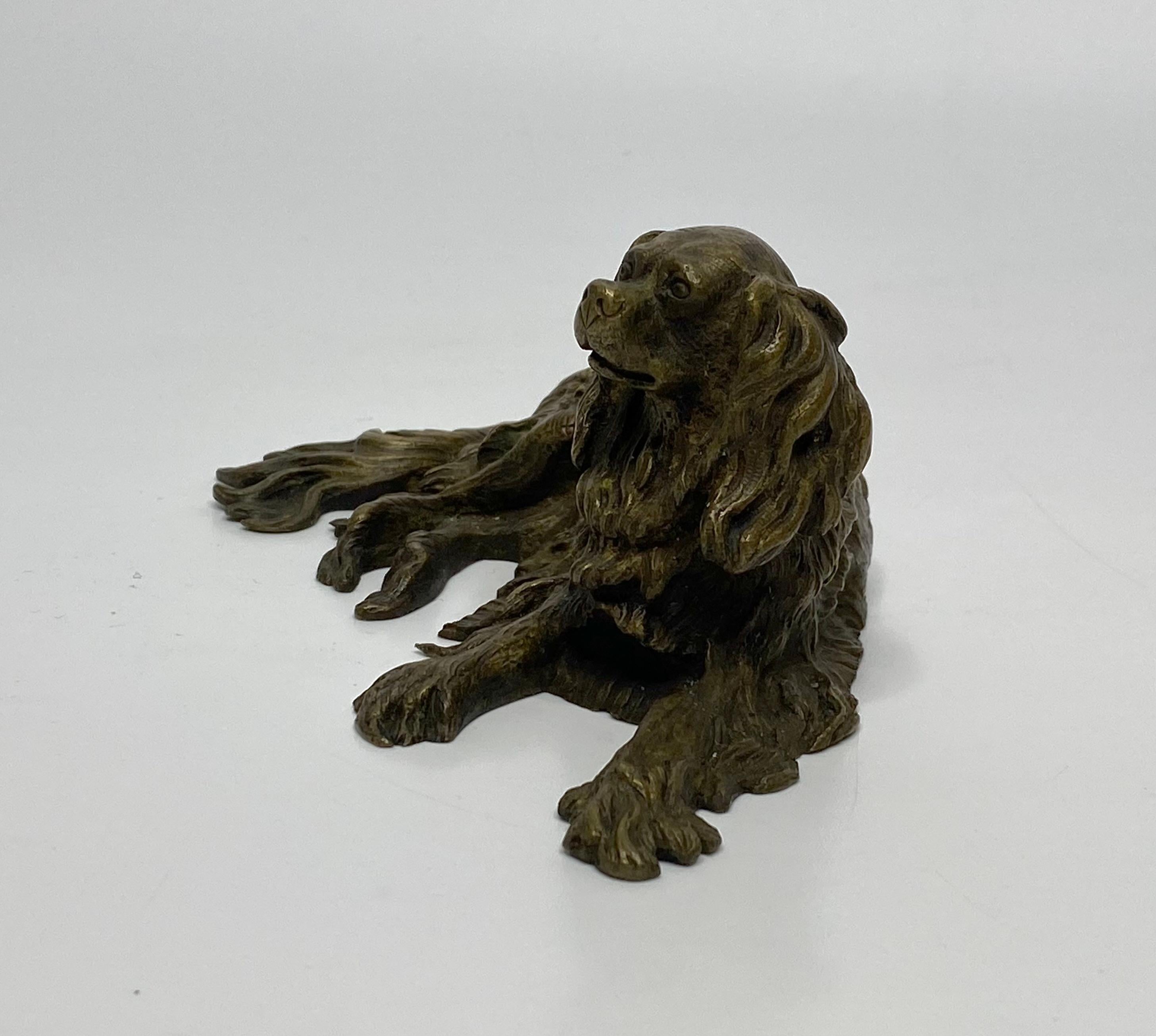 A bronze figure of a Spaniel, England, c. 1840. The recumbent Spaniel with a charming expression on its face, finely cast, and hand finished, with its hair intricately rendered.
Length – 15.2 cm, 6”.
Height – 6.2 cm, 2 3/8”.
Depth – 7.5 cm,