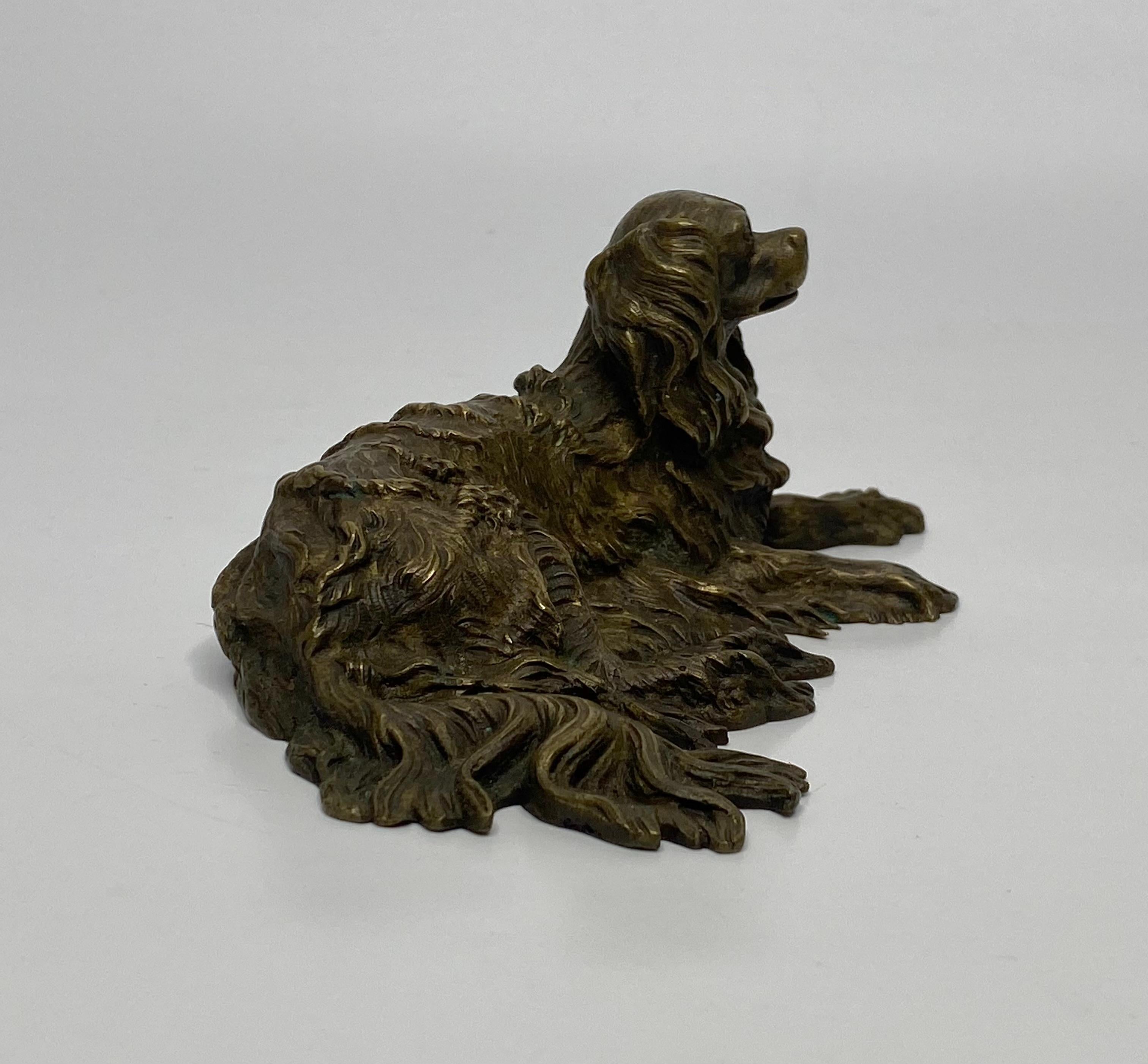 Cast English bronze recumbent Spaniel, c. 1840. For Sale