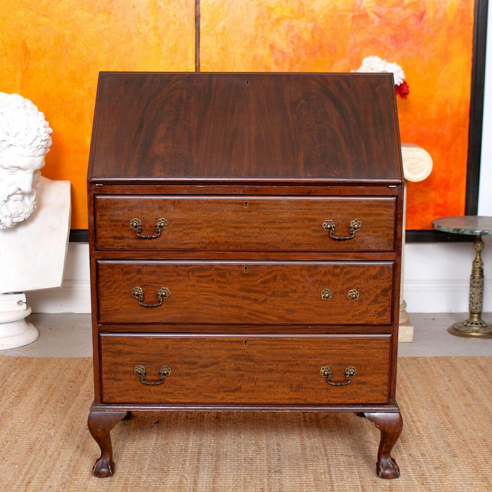 An impressive early 20th century walnut writing bureau.

The marquetry adorned fall flap enclosed tooled leather writing surface and fitted interior comprising miniature drawers and cubby holes. Fitted three long graduated drawers below with